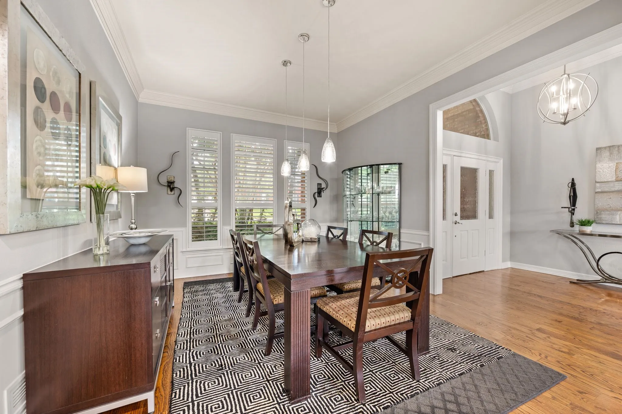 Formal dining space featuring hardwood flooring and extensive crown molding
