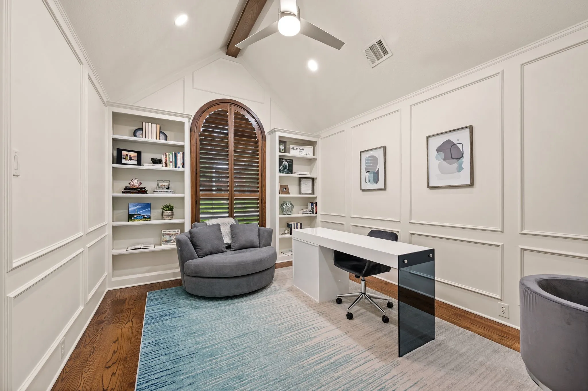 Vaulted ceiling with exposed wood beam and ceiling fan