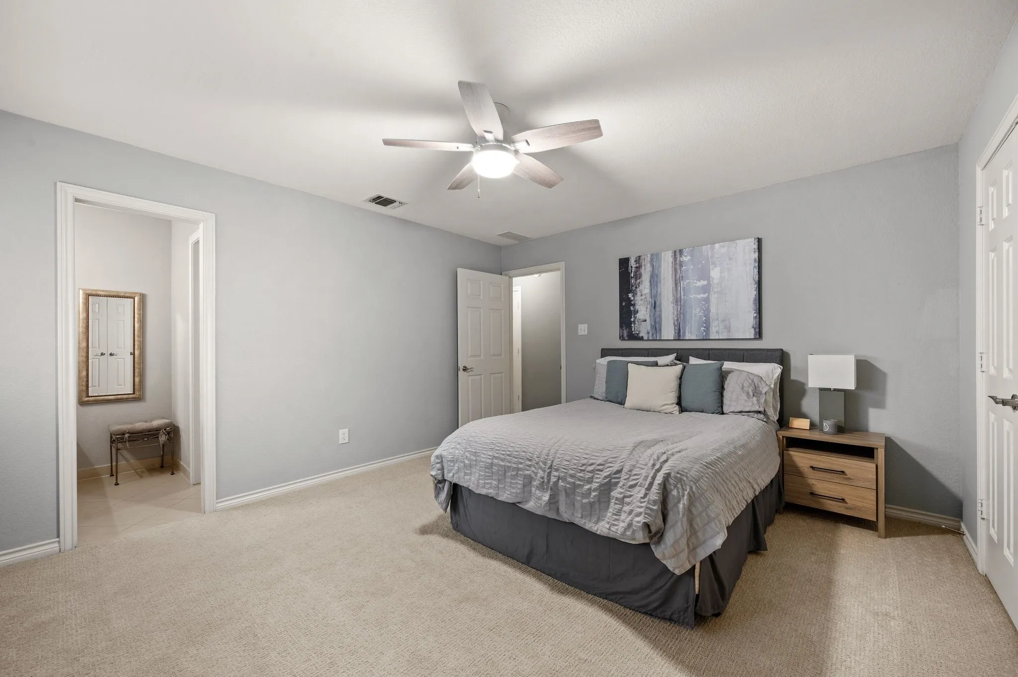 Light gray walls complementing plush carpet flooring