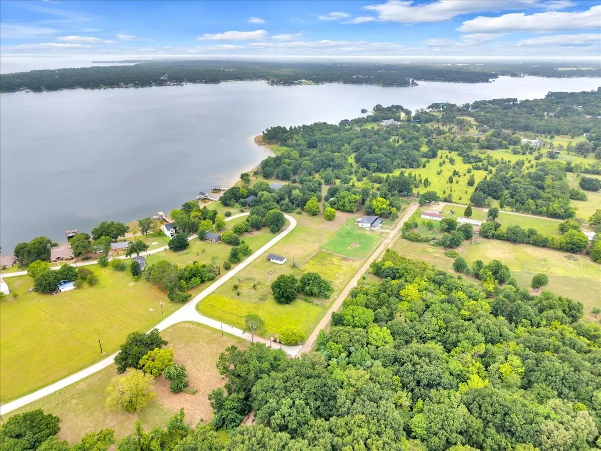 Expansive aerial perspective showcasing a significant body of water bordered by a lush green landscape