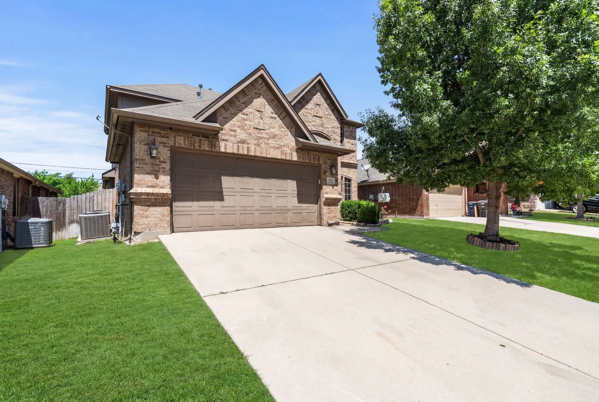 Brick exterior with stone accents and a two-car garage