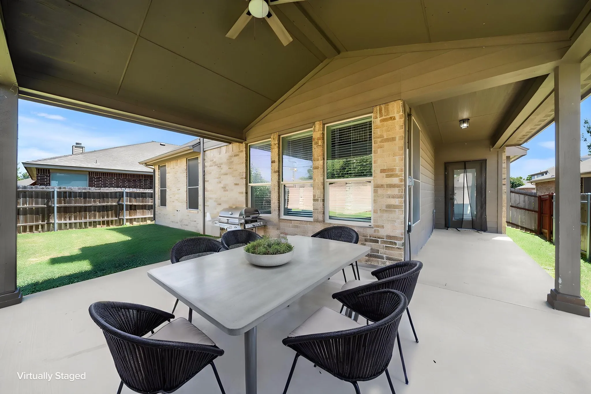 Expansive covered patio featuring a ceiling fan, recessed lighting, and a concrete slab