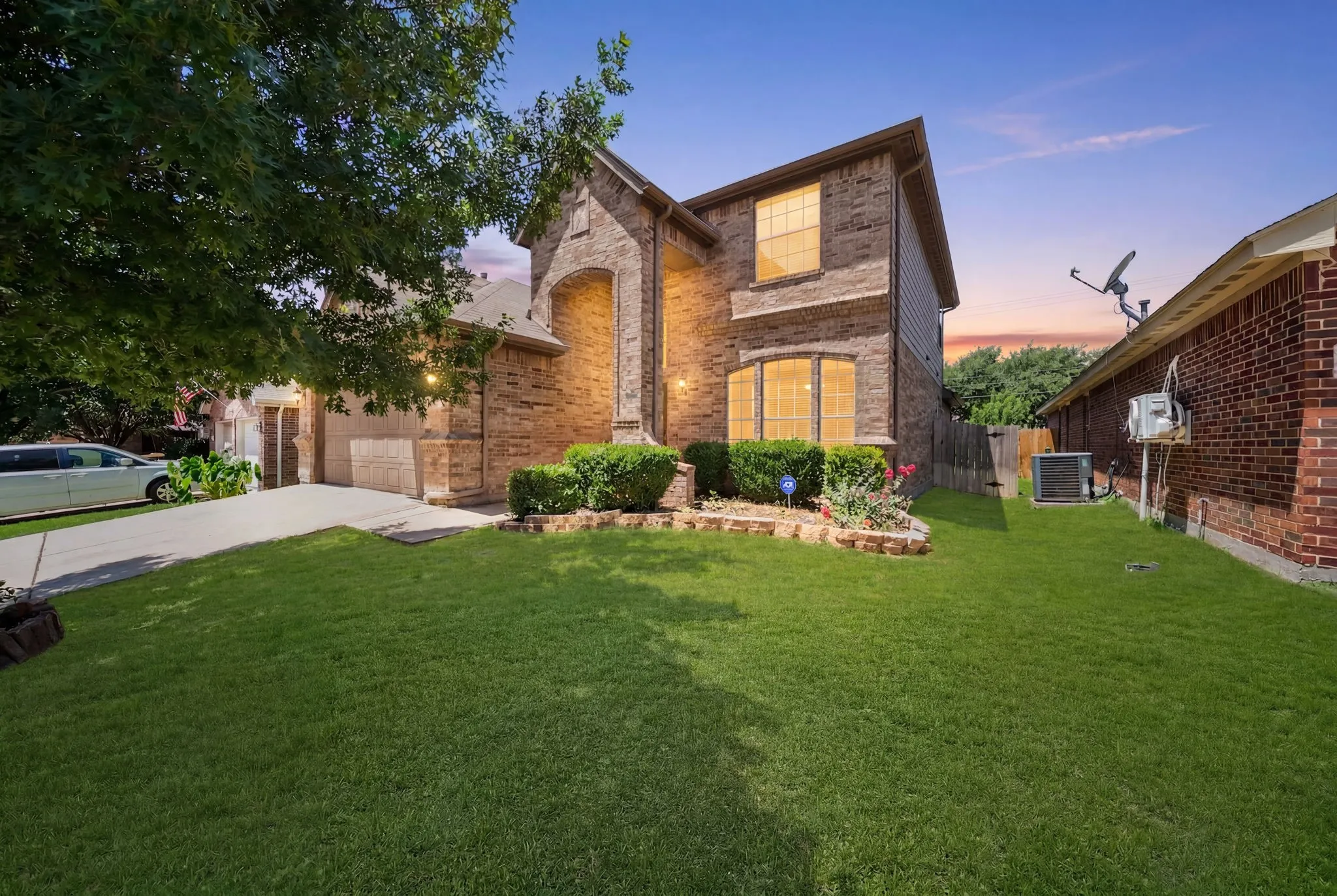 Two-story brick and stone facade residence featuring arched entryways