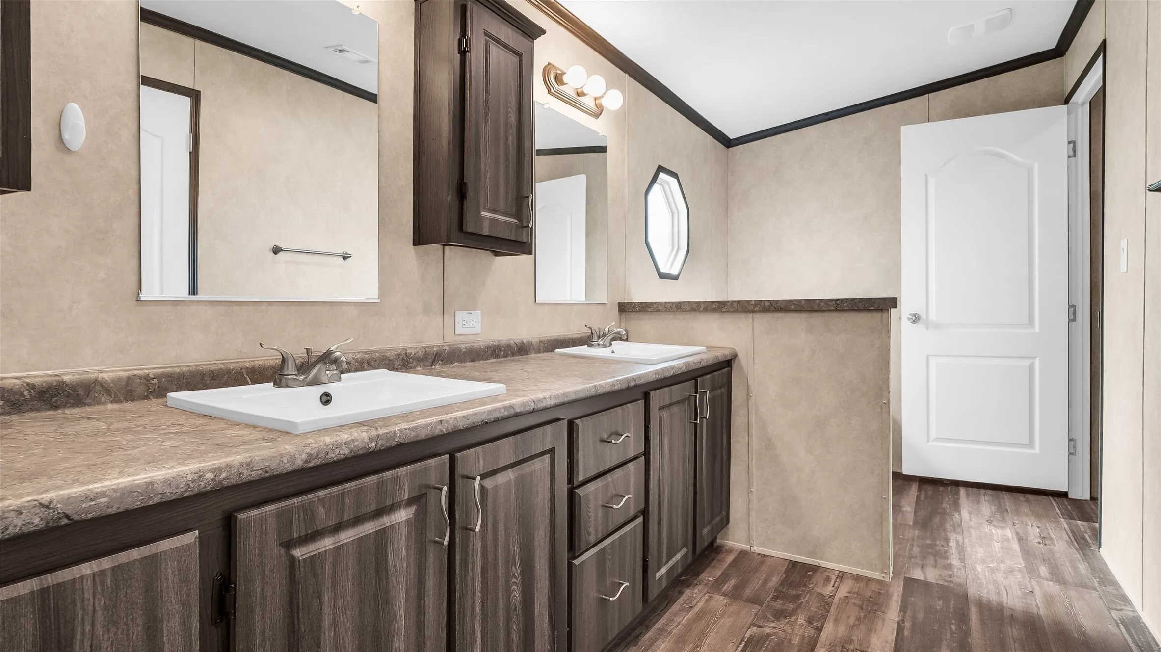 Dual vanity with integrated sinks and wood-finish cabinetry