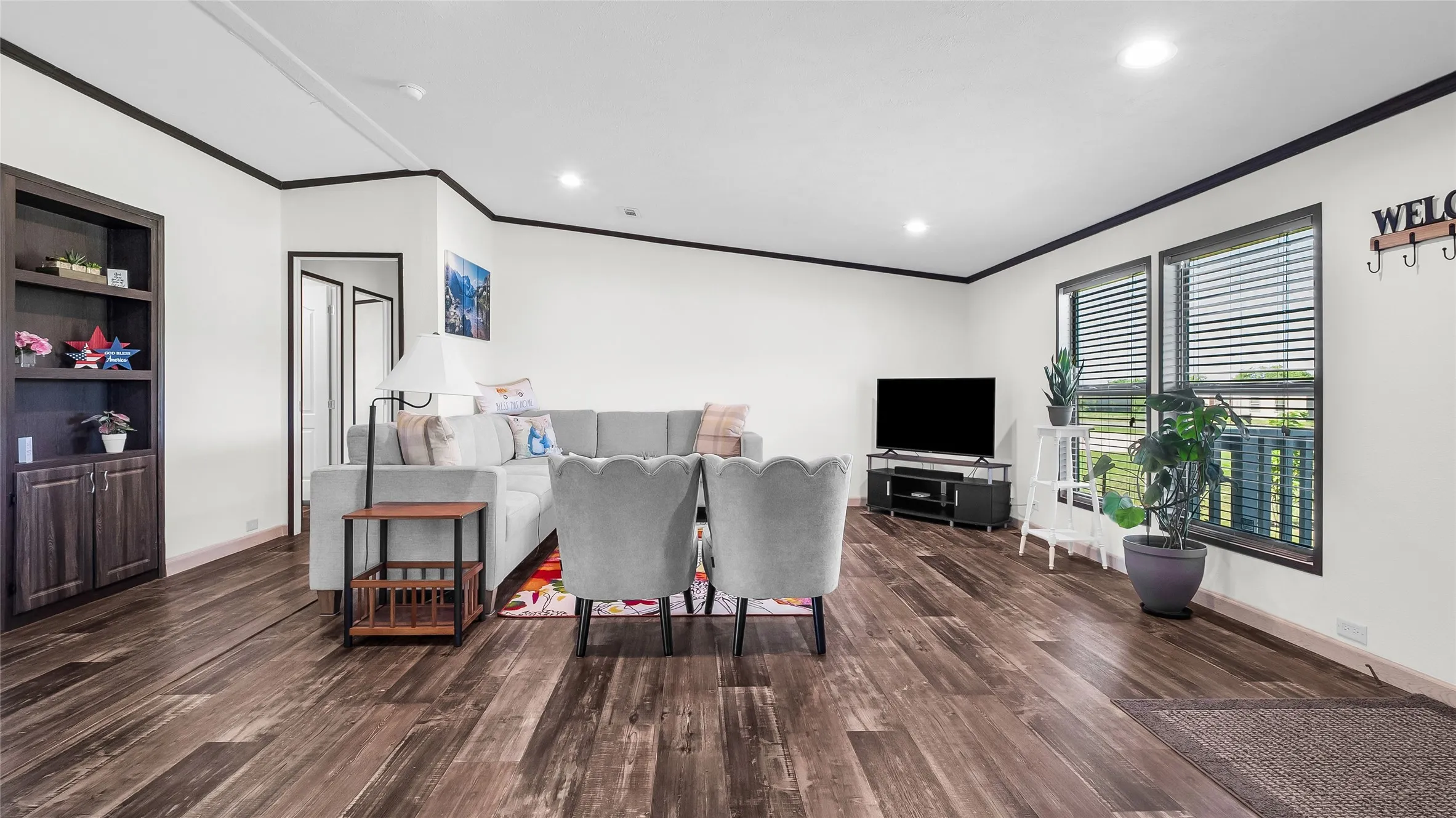 Spacious living area featuring laminate flooring and recessed lighting