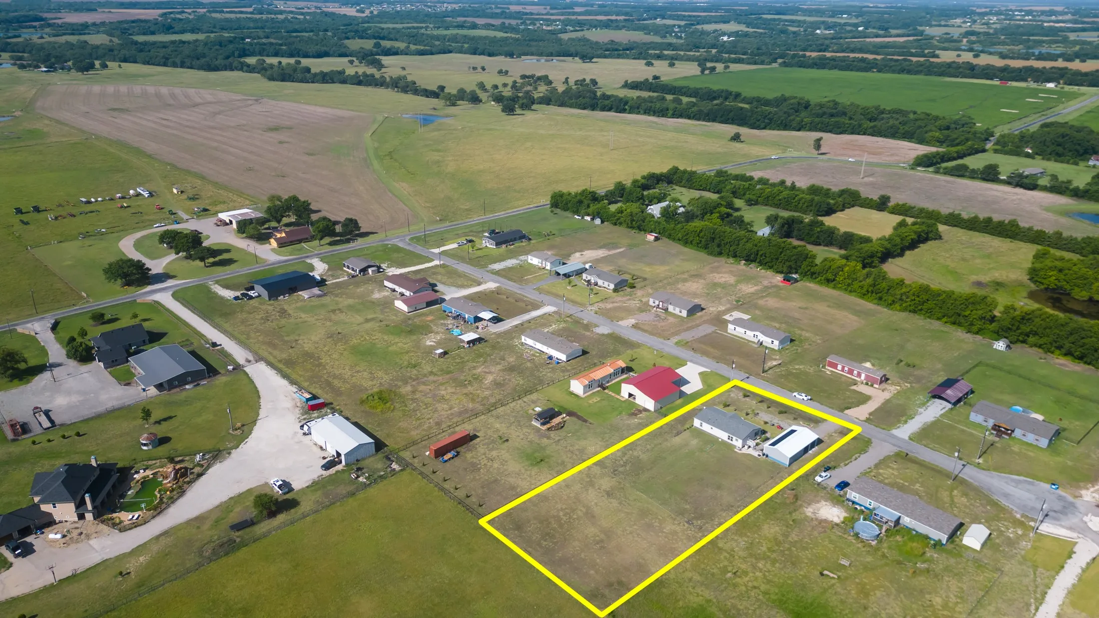 Expansive property outlined in yellow, featuring a single-story residence with an attached covered structure