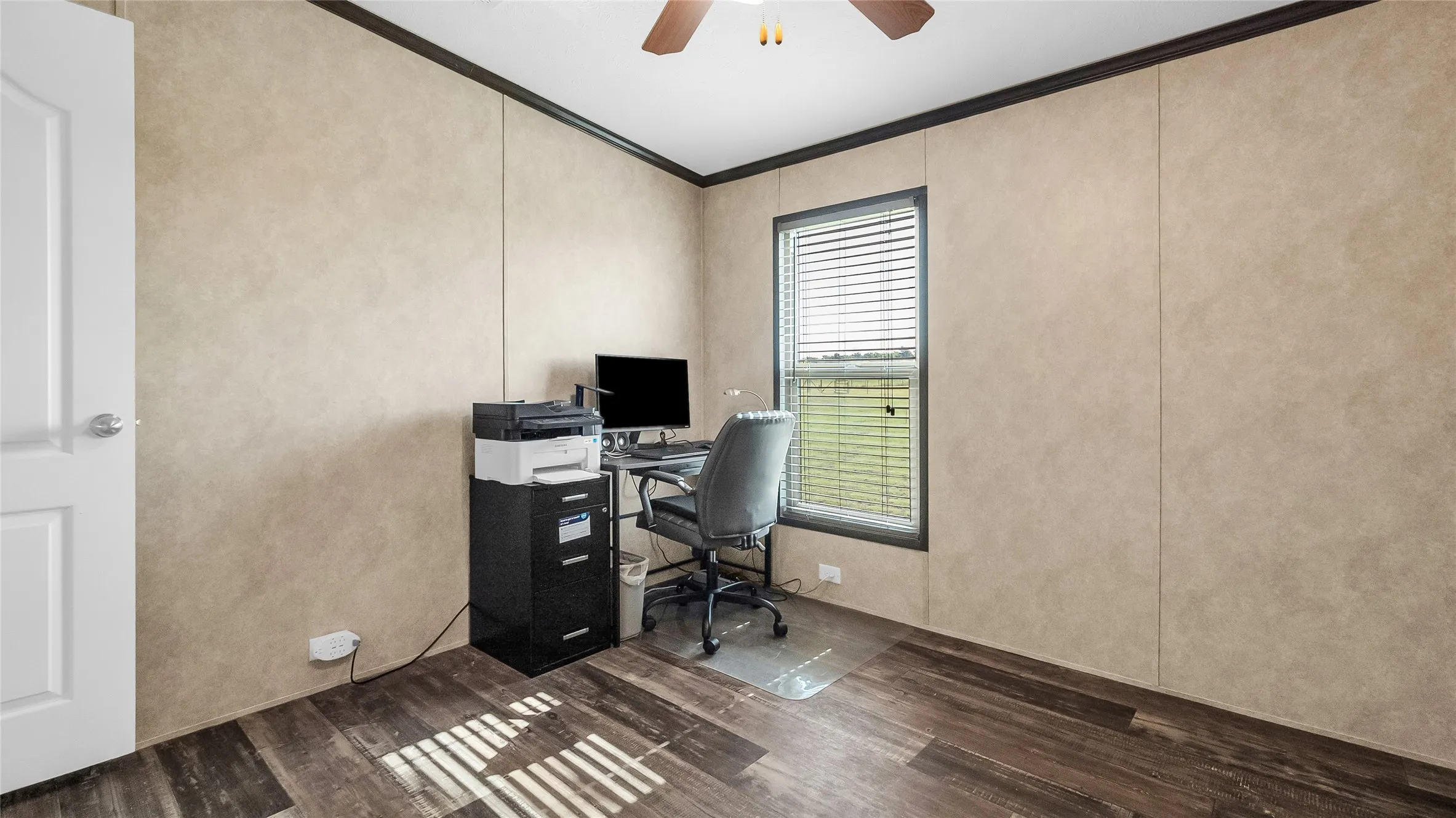 Room featuring laminate flooring, a window with horizontal blinds, and a white interior door