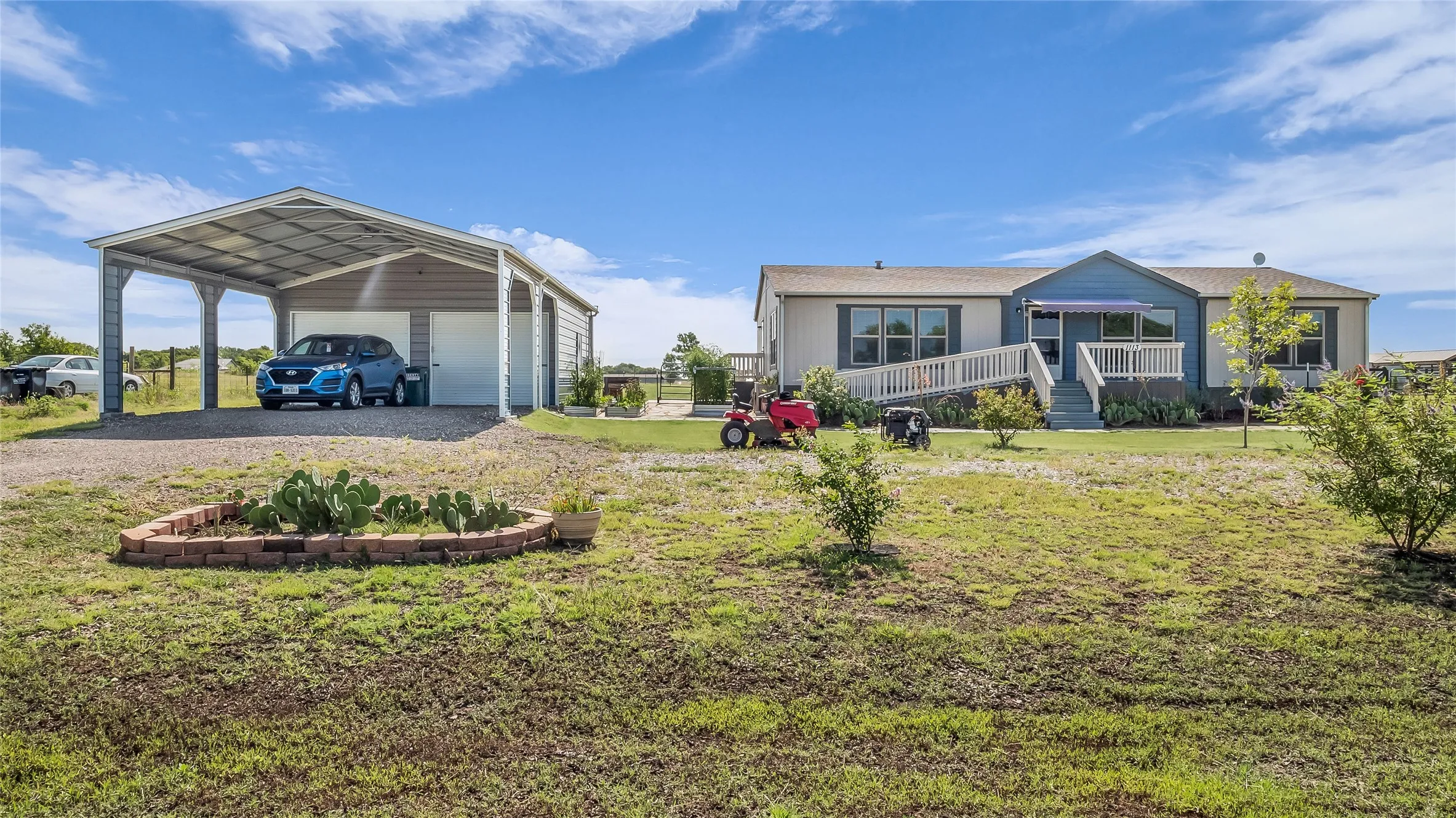 Expansive property featuring a single-story residence with a covered front deck and ramp access