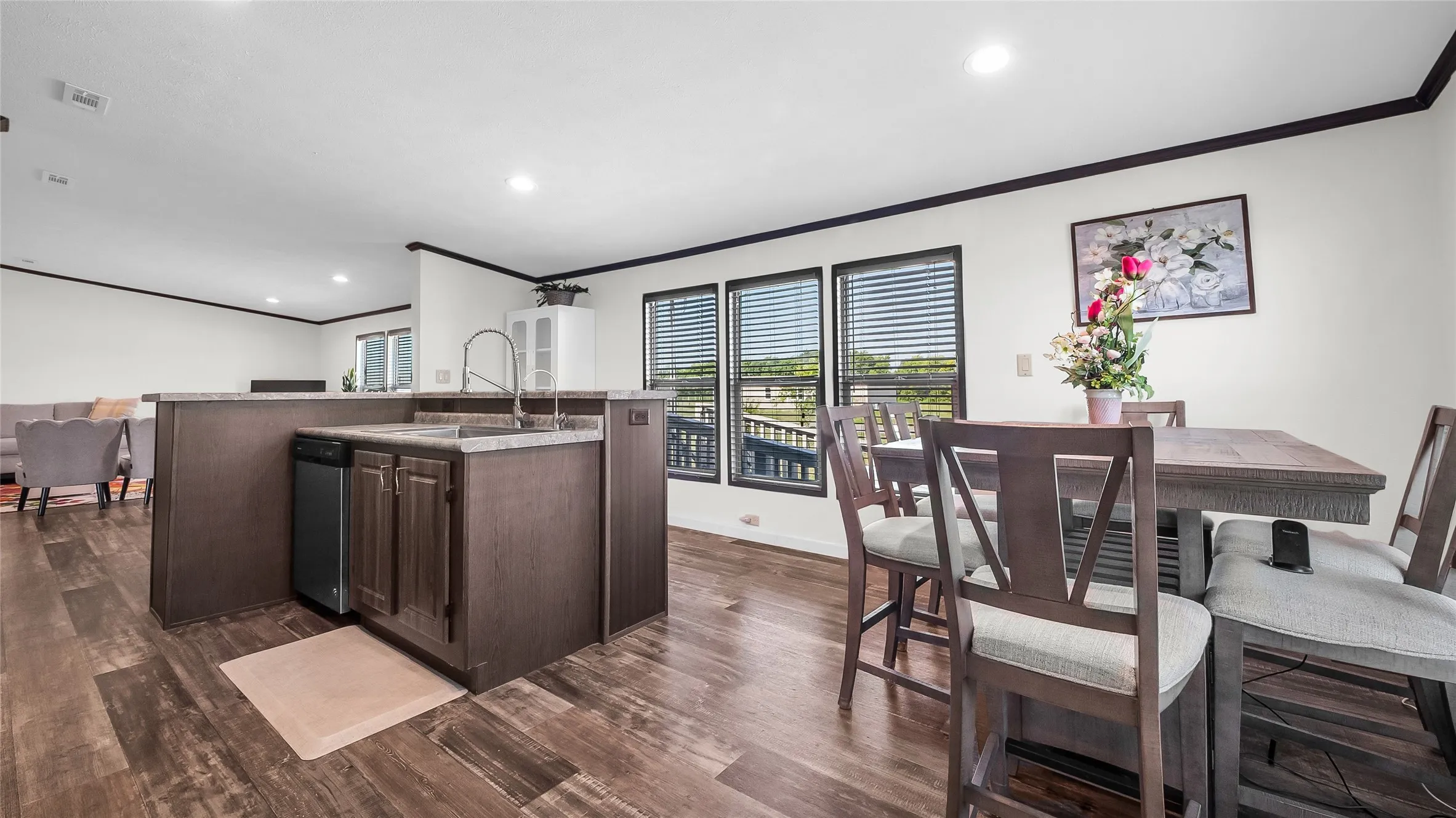 Open-concept kitchen and dining area with laminate flooring