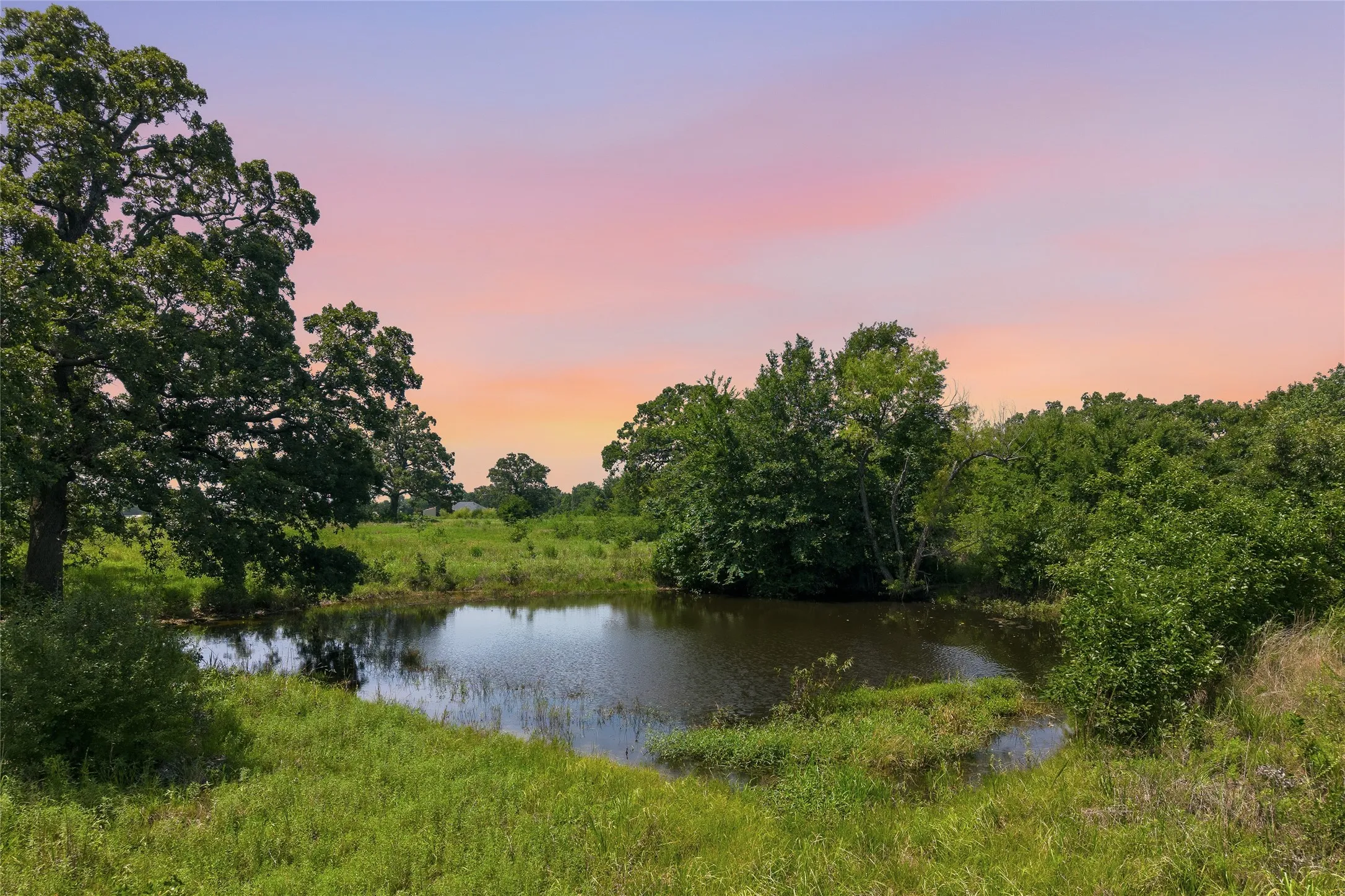 Property pond near front left corner at sunset
