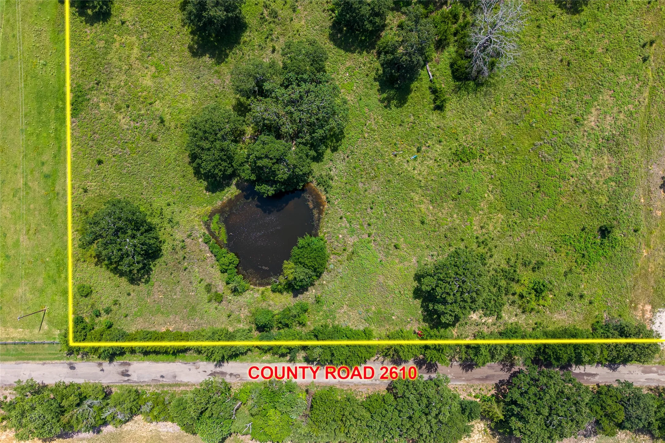 Aerial of CR 2610 with front left corner of property and entrance