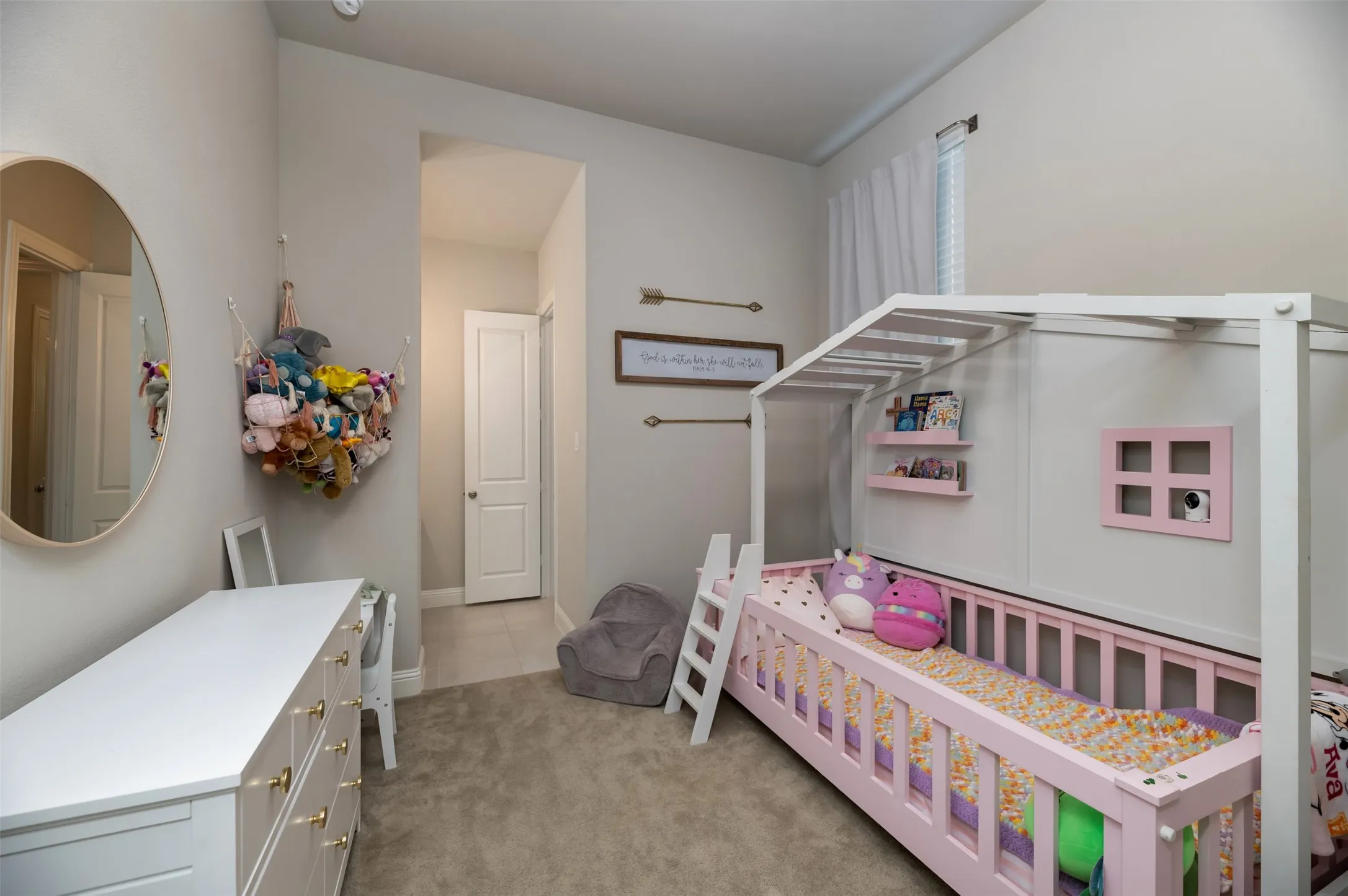 Carpeted room with vaulted ceilings and neutral wall paint