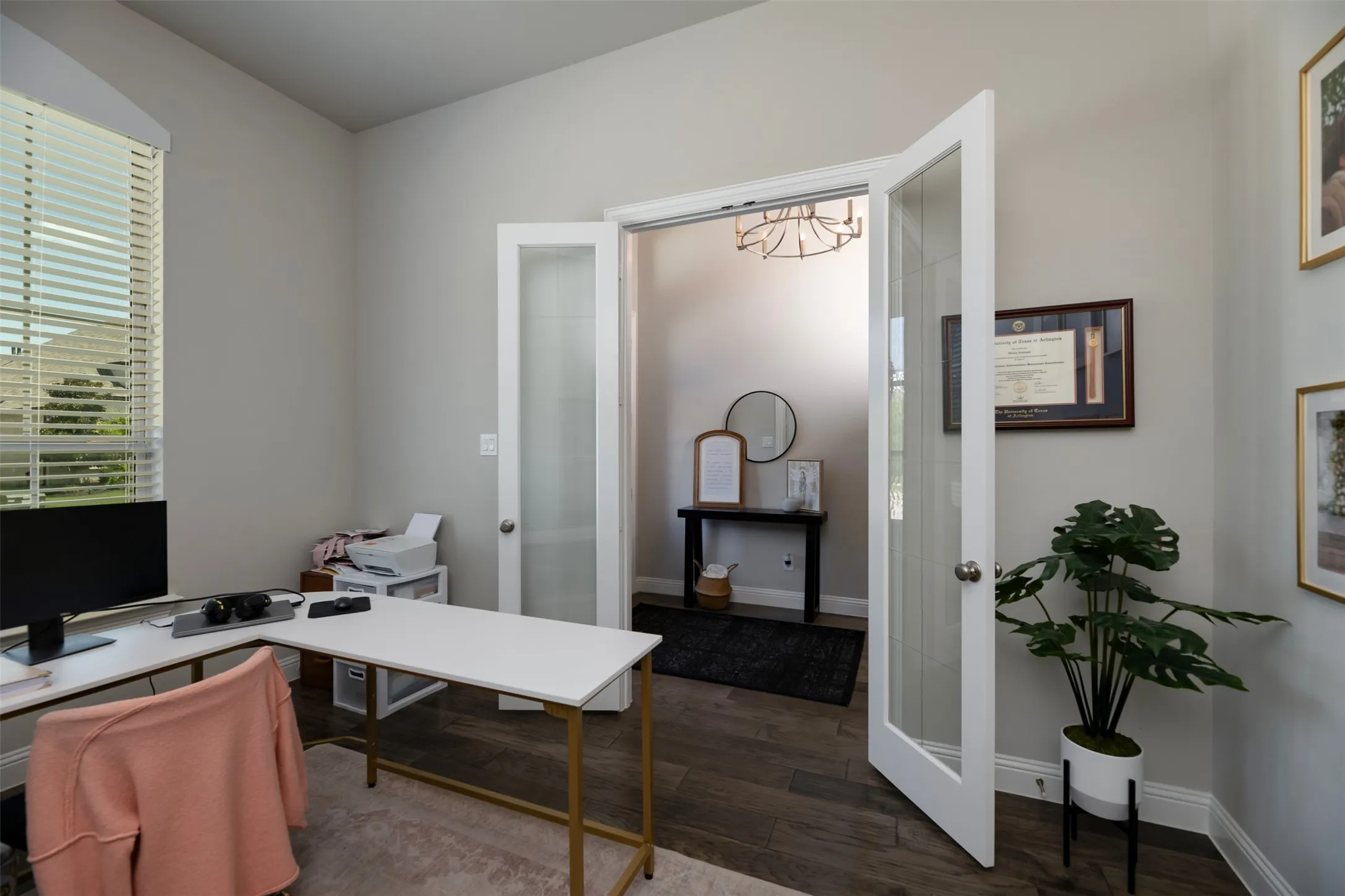 Vaulted ceilings enhance this space featuring wood-finish flooring and neutral wall tones