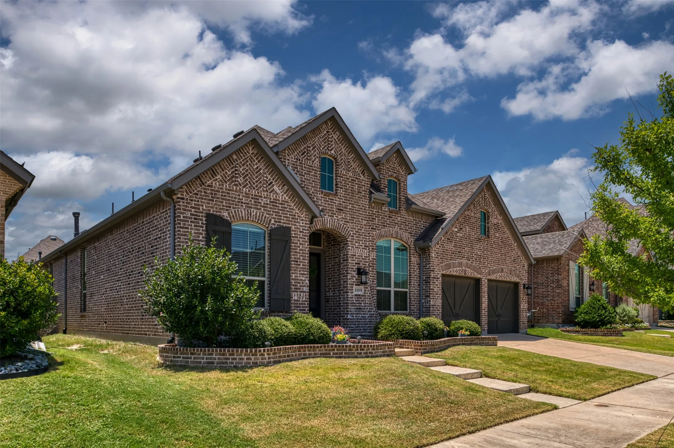 Brick-clad exterior with gabled roof lines and dark-trimmed windows