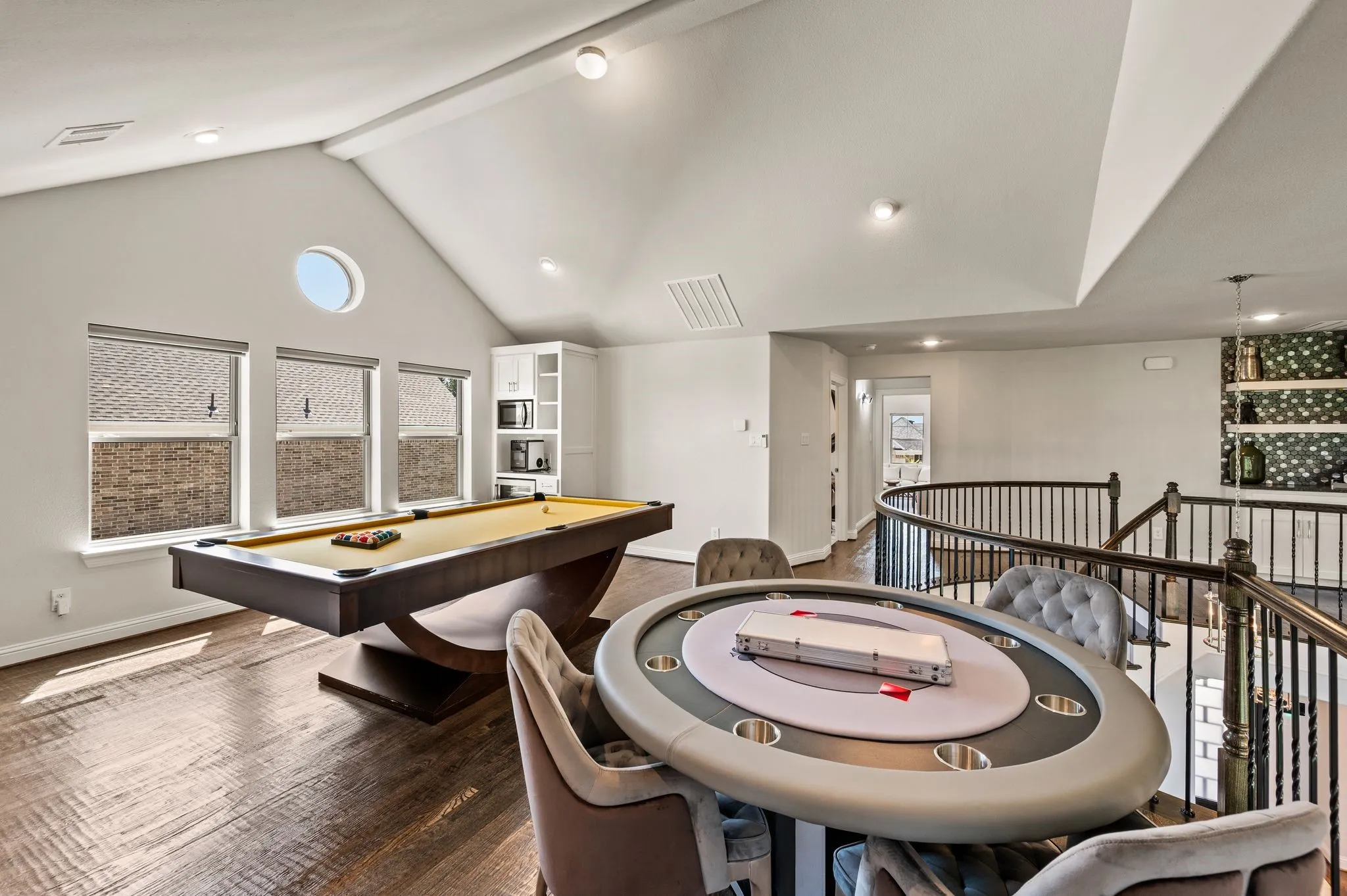 Game room has it's own corner dry-bar with beverage fridge (which conveys) to the left; To the right is another custom built-in dry-bar to serve upstairs dwellers