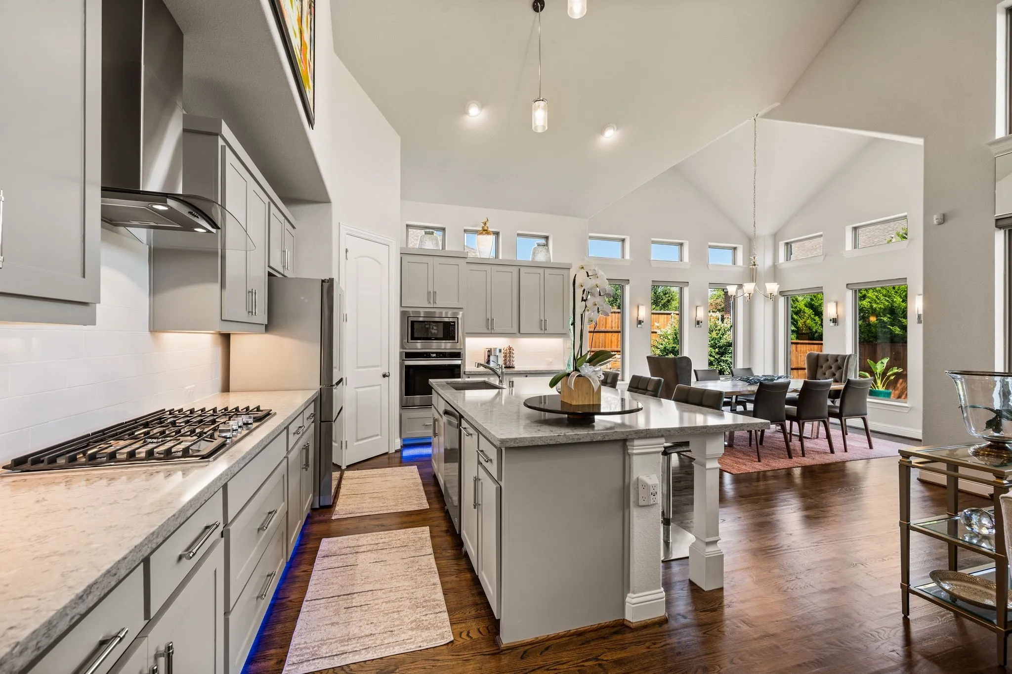 Classic Shaker-style cabinetry; Stainless appliances; 5-burner gas cooktop; Dedicated Coffee or Butler station; More undermount lighting; Continuous transom window light floods the home