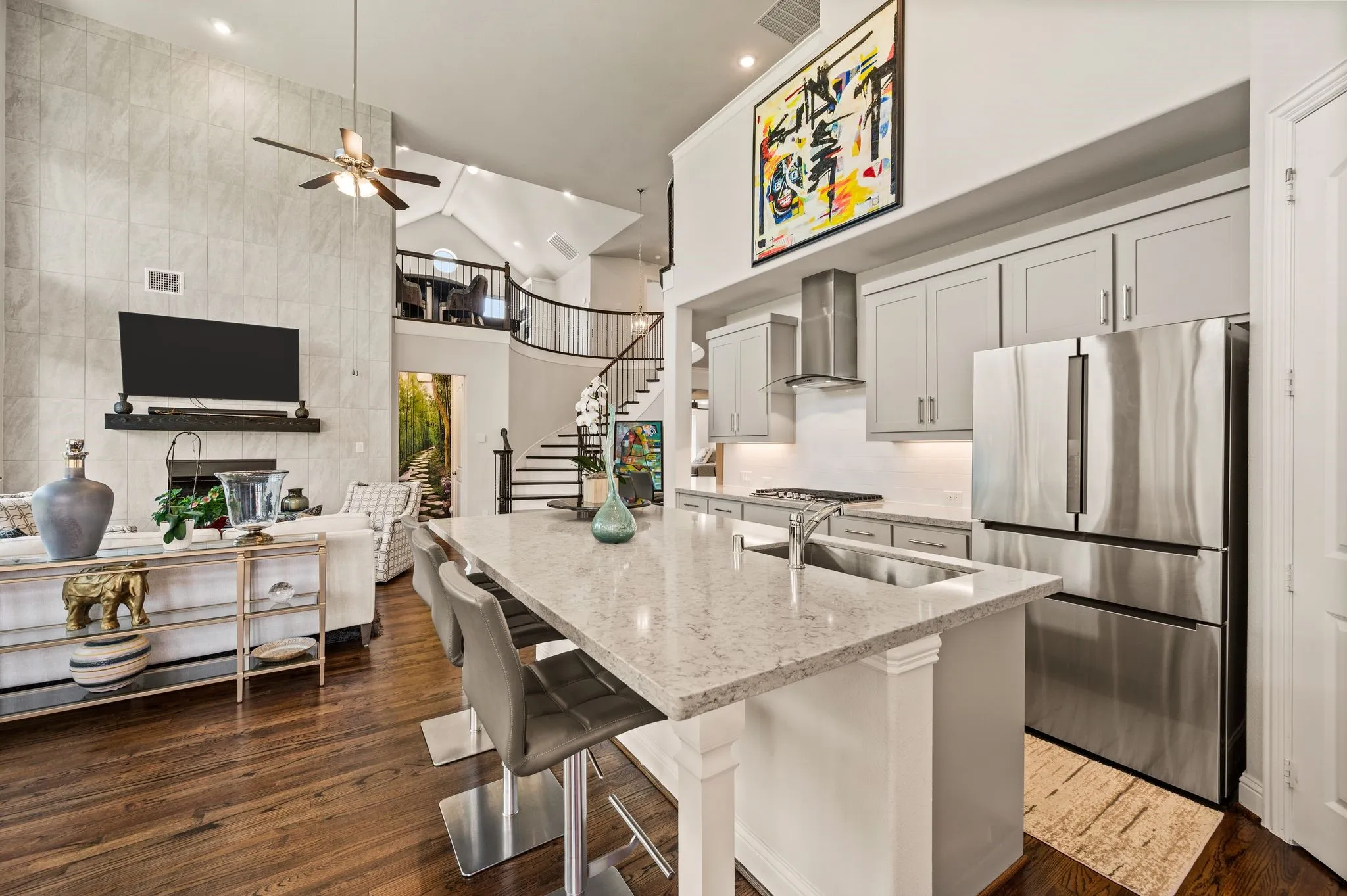 Wood flooring extends throughout the entire downstairs (tile in bathrooms and laundry); Open-concept; Serene color palette throughout