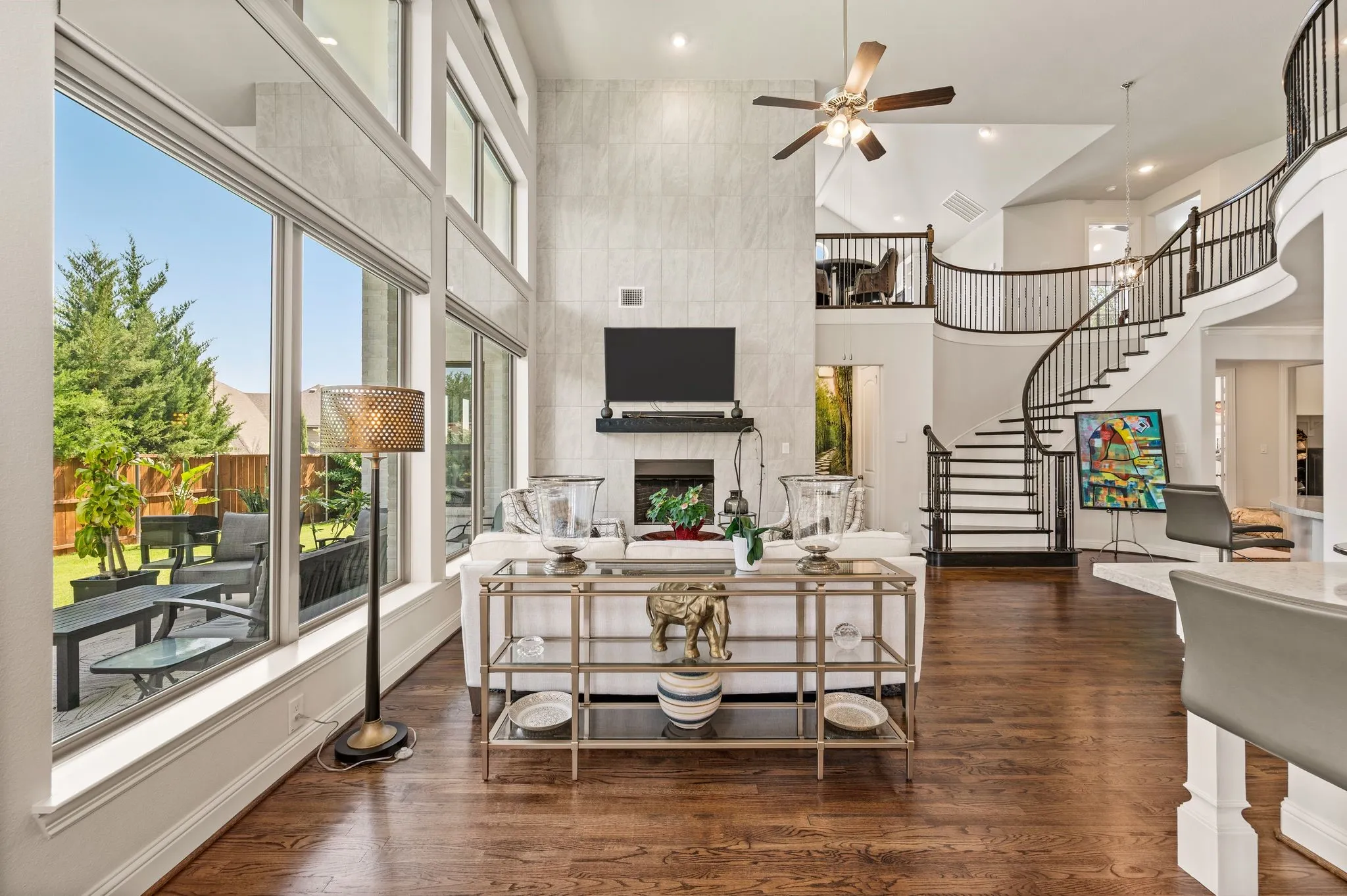 Fireplace has floor-to-ceiling tile, an electric wall switch, gas logs, and a flue for optional wood burning