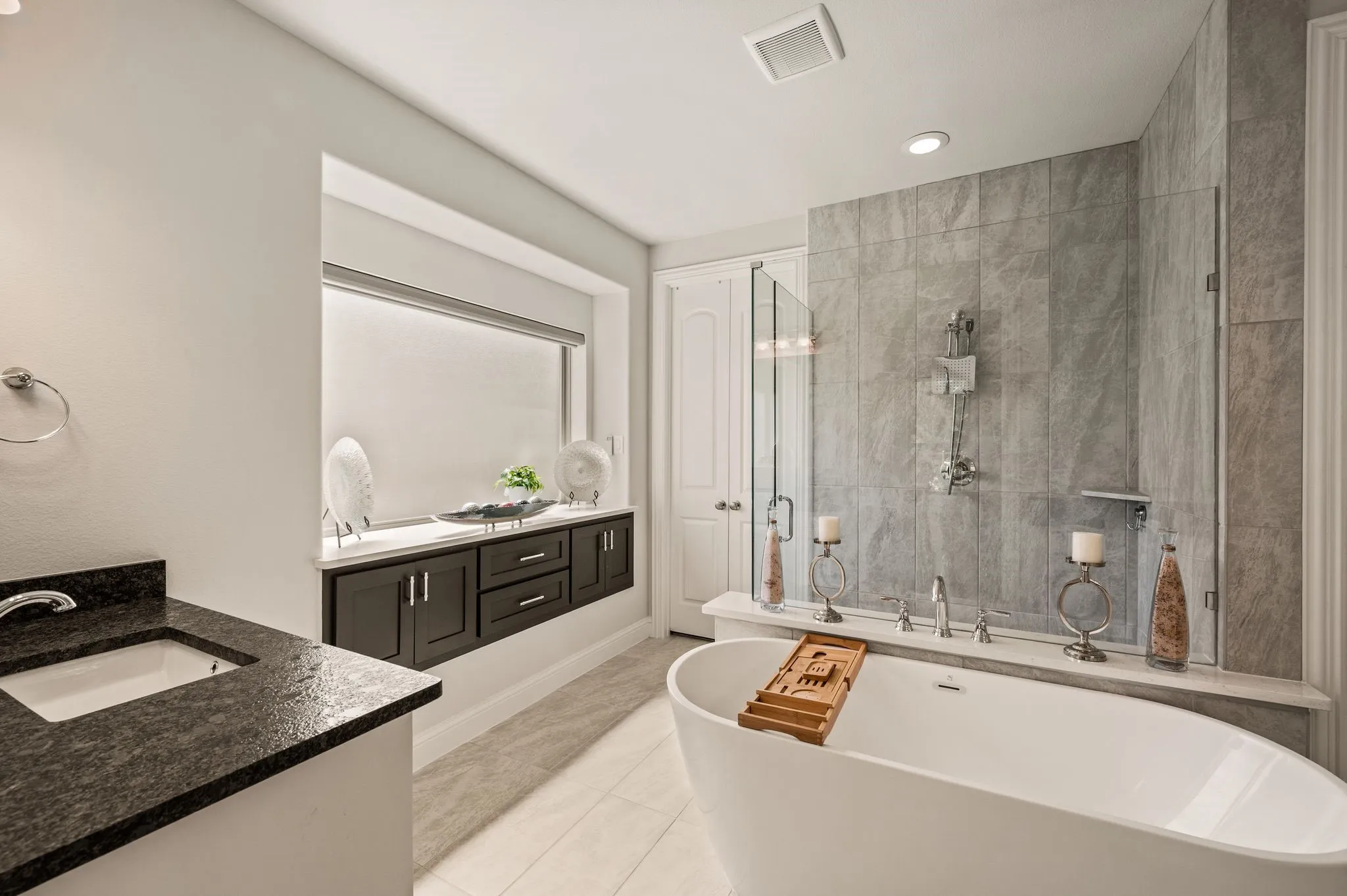 Note the custom Built-in for extra storage; Free-standing soaking tub; Separate seamless-glass framed shower