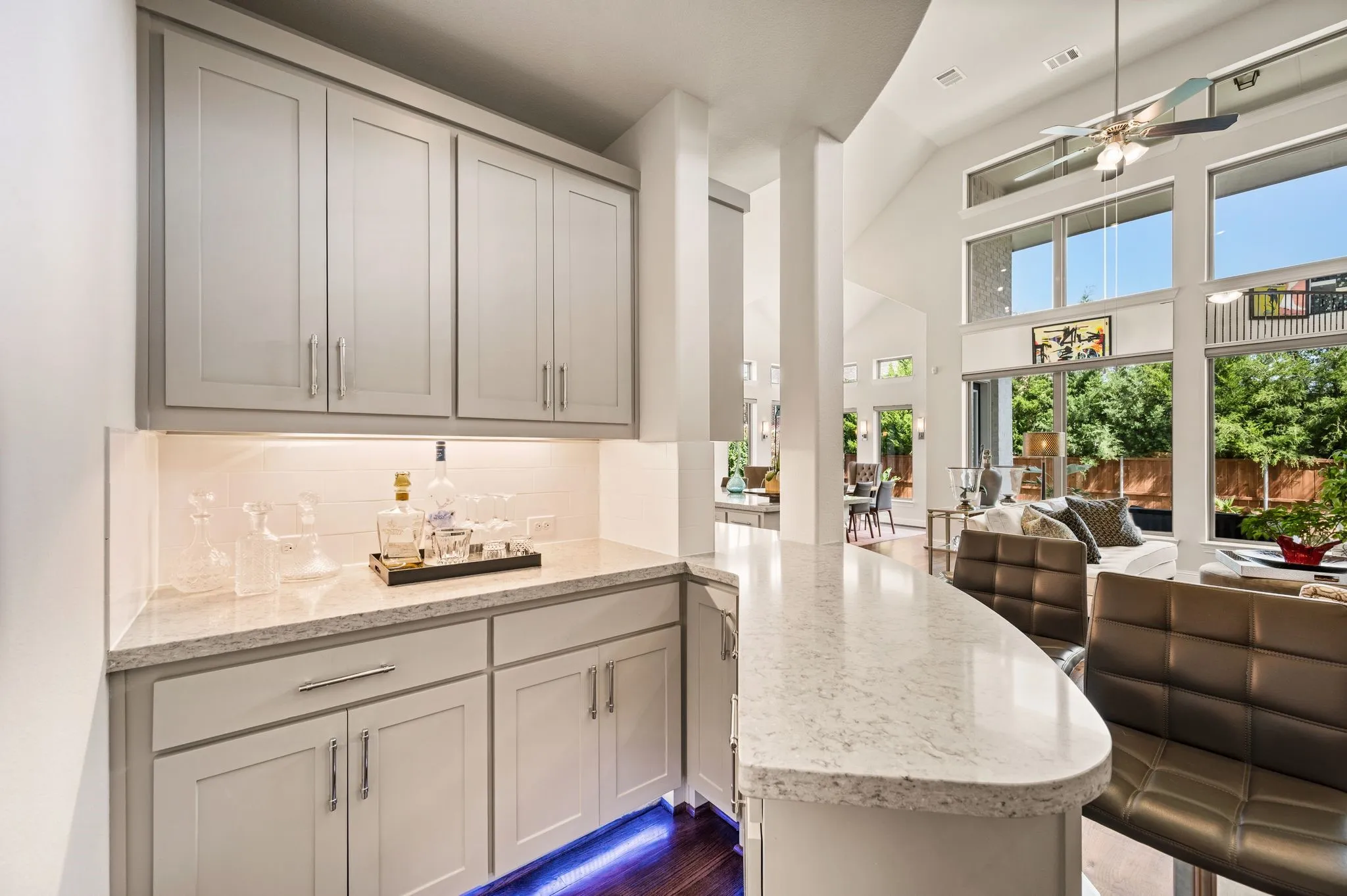 Massive downstairs Bar area is between Formal and Informal areas; Notice Omega stone countertops, full backsplash, undermount cabinetry lighting