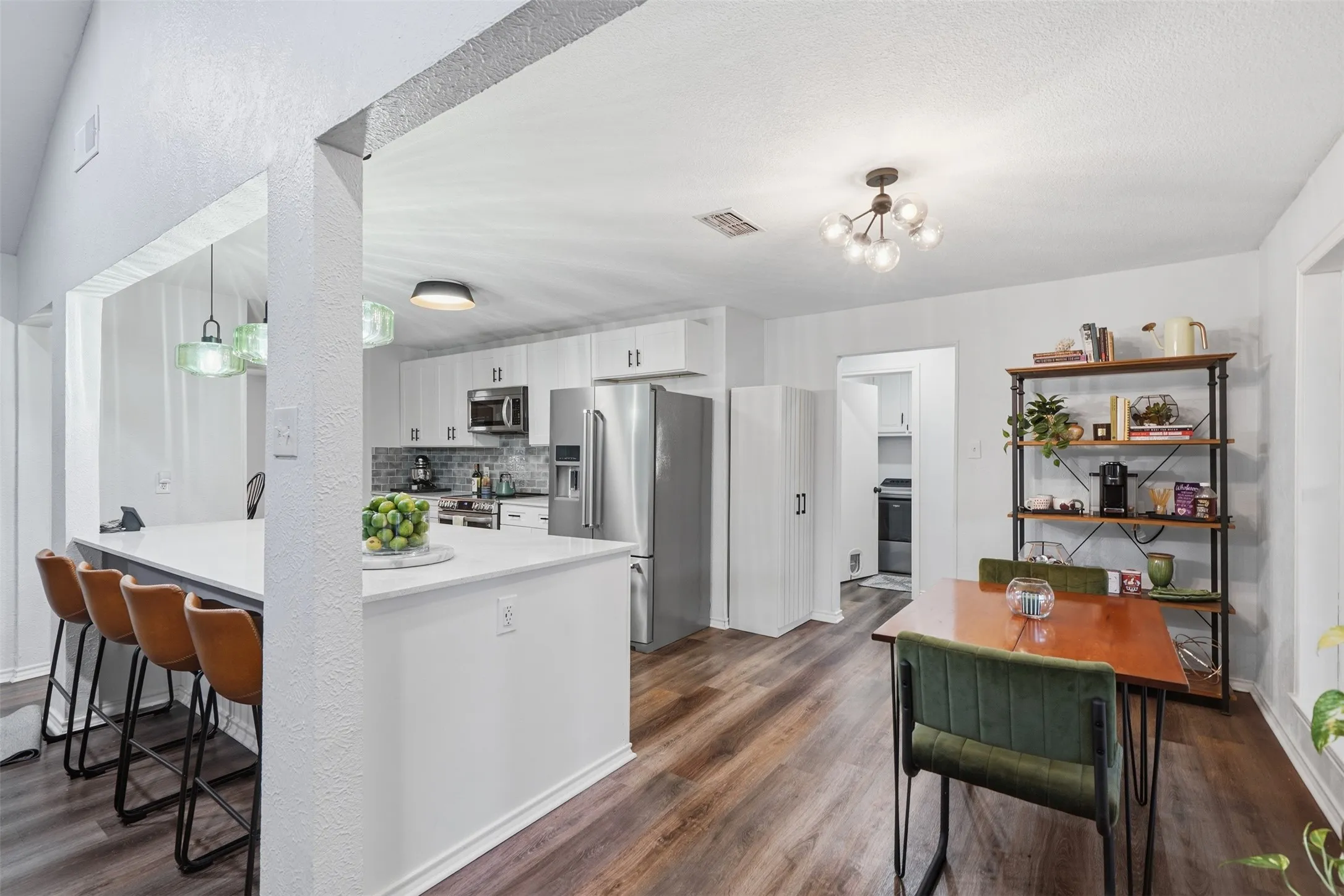 Large island with seating, eat-in breakfast area, connects to primary suite and living area