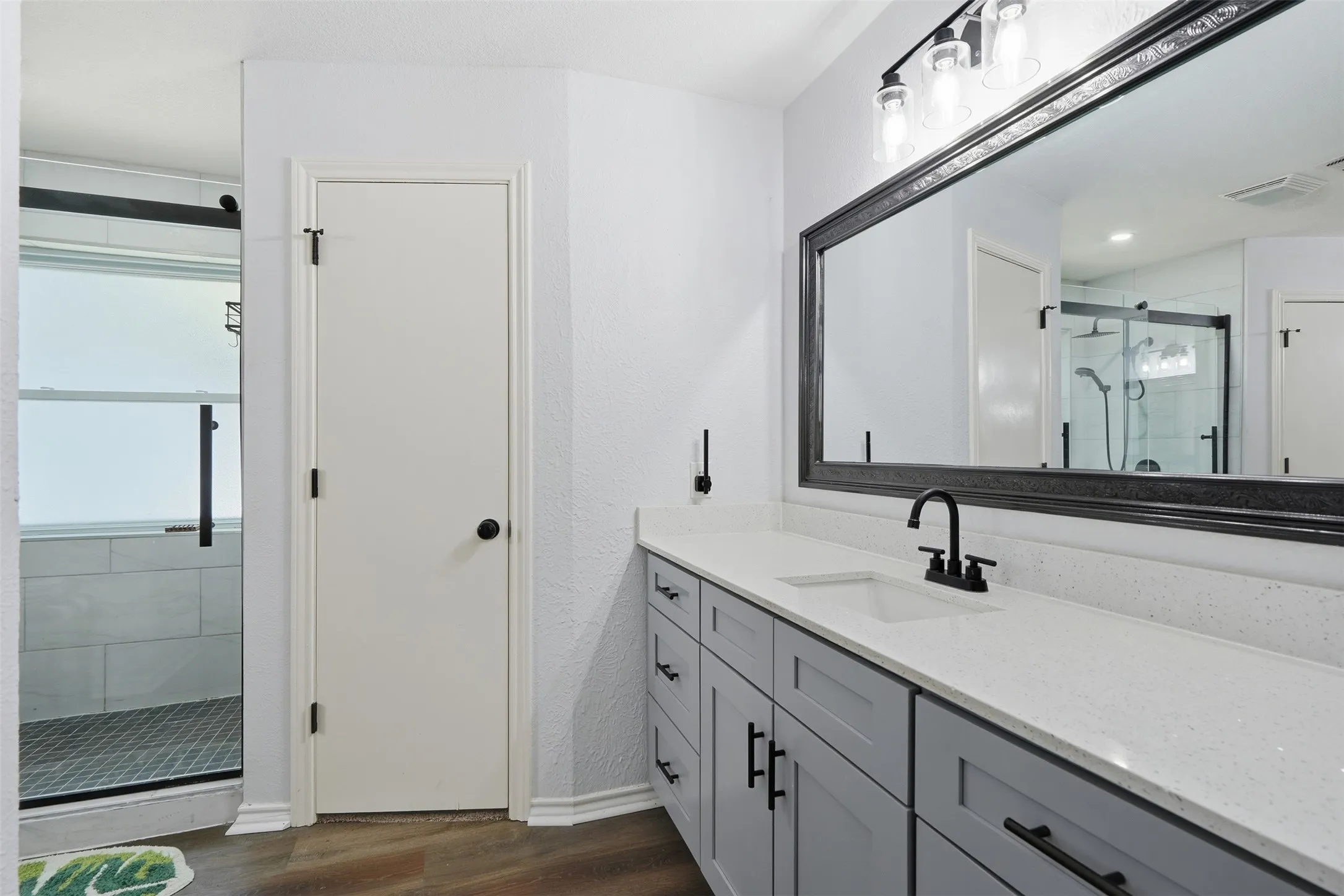 Primary suite with 2 separate vanities and 2 walk in closets