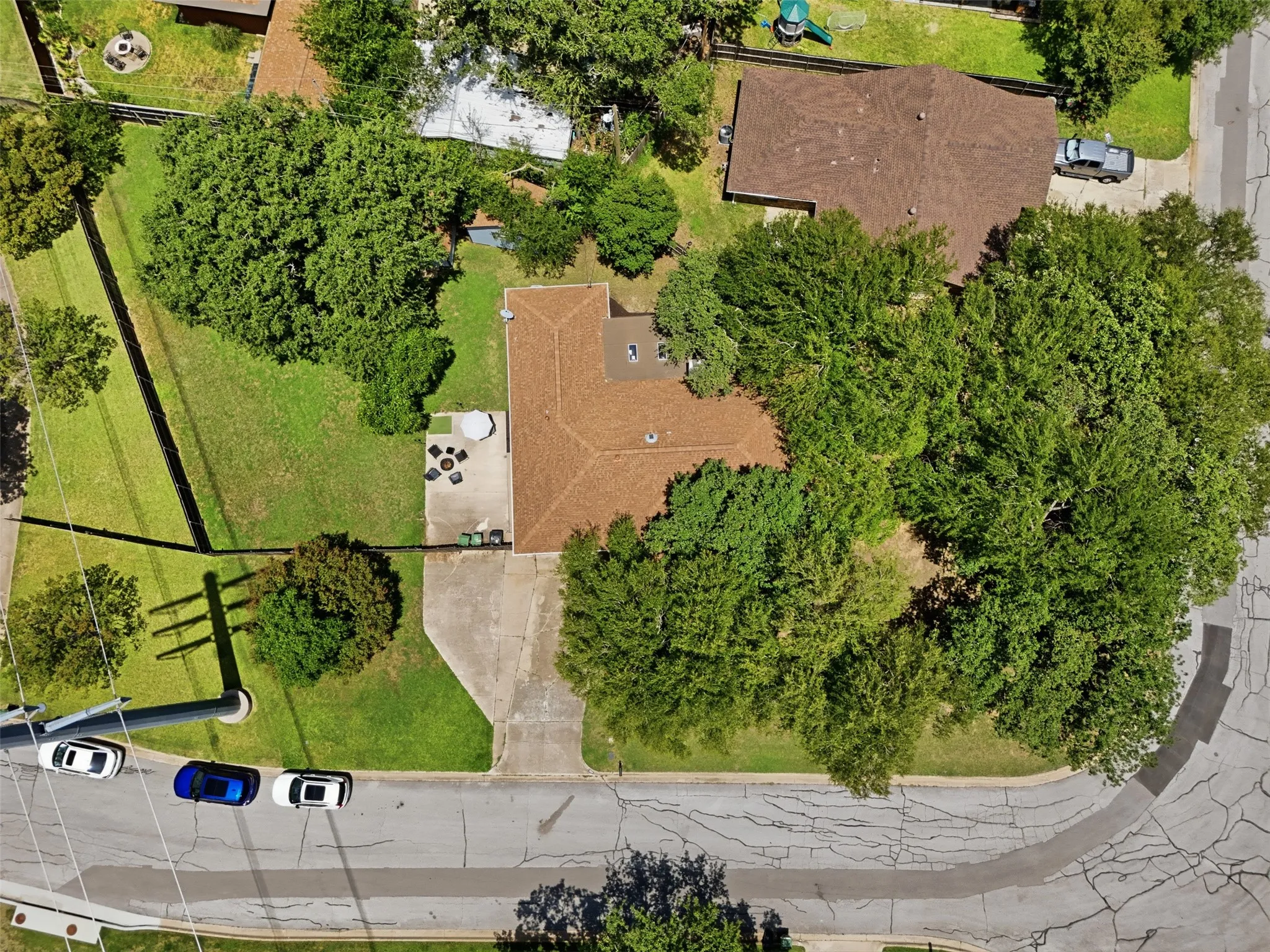 Large corner lot with mature trees and 2 storage sheds