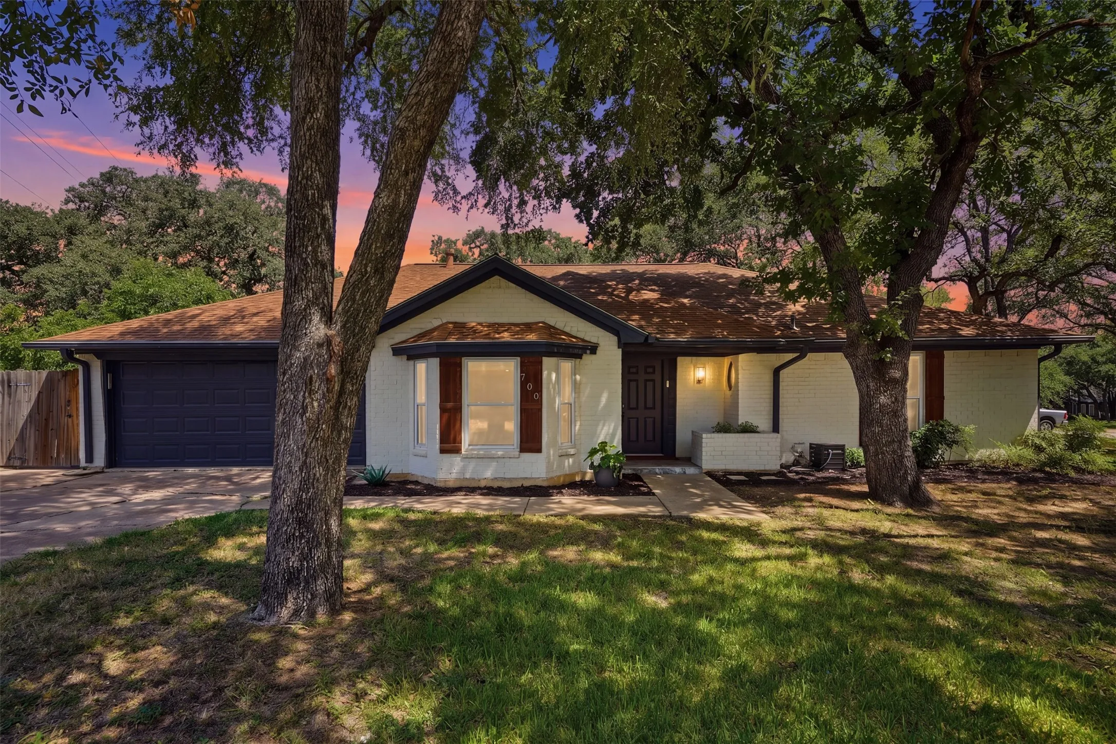 Mature trees, 2-car garage, extended driveway with gated parking for RV's, boats, trailers, or makes great outdoor living!