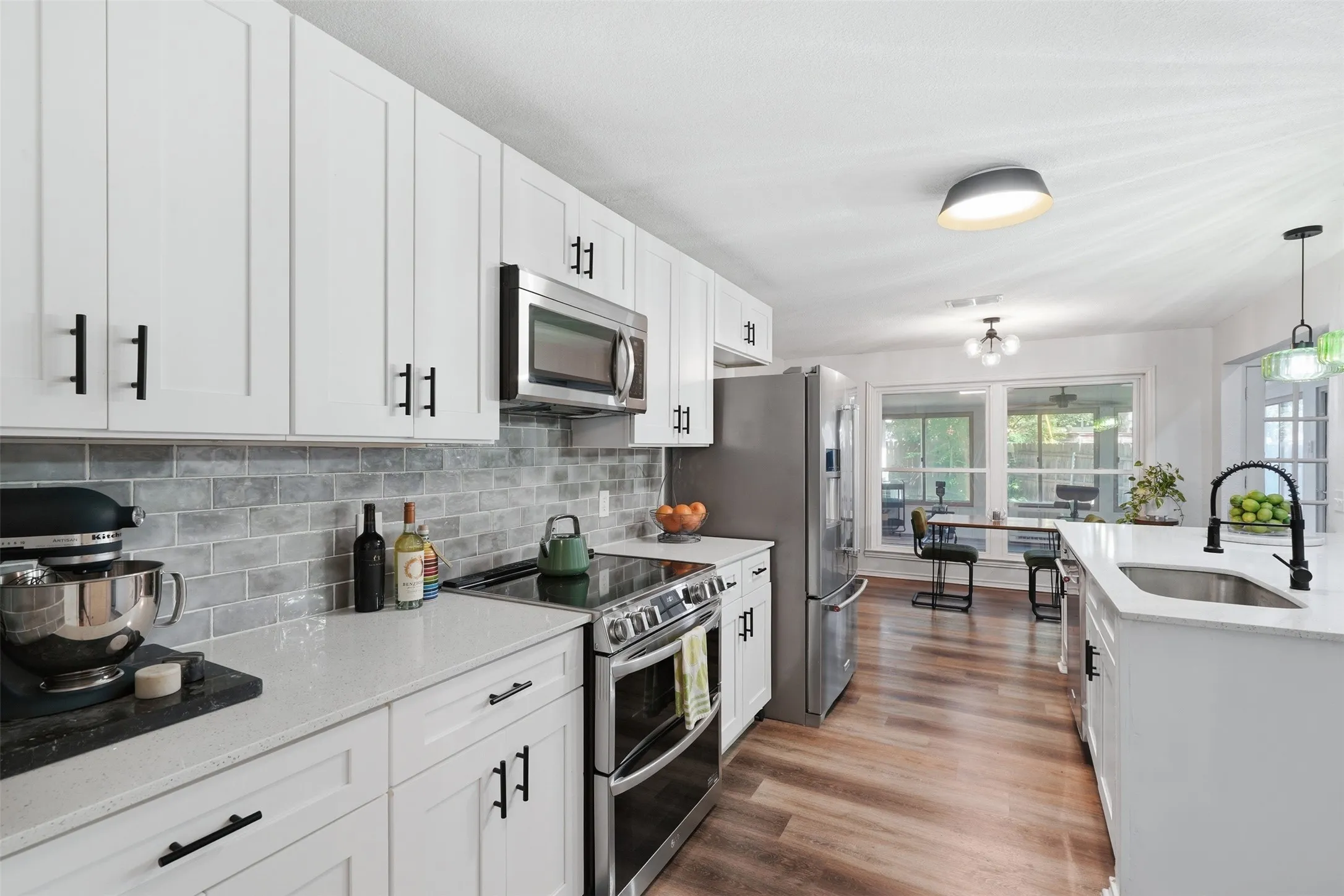 Quartz counter tops, shaker-style cabinets, large island with storage and seating.