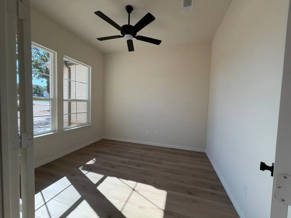 Recessed lighting, wood-finish flooring, two large windows, white trim, and a ceiling fan