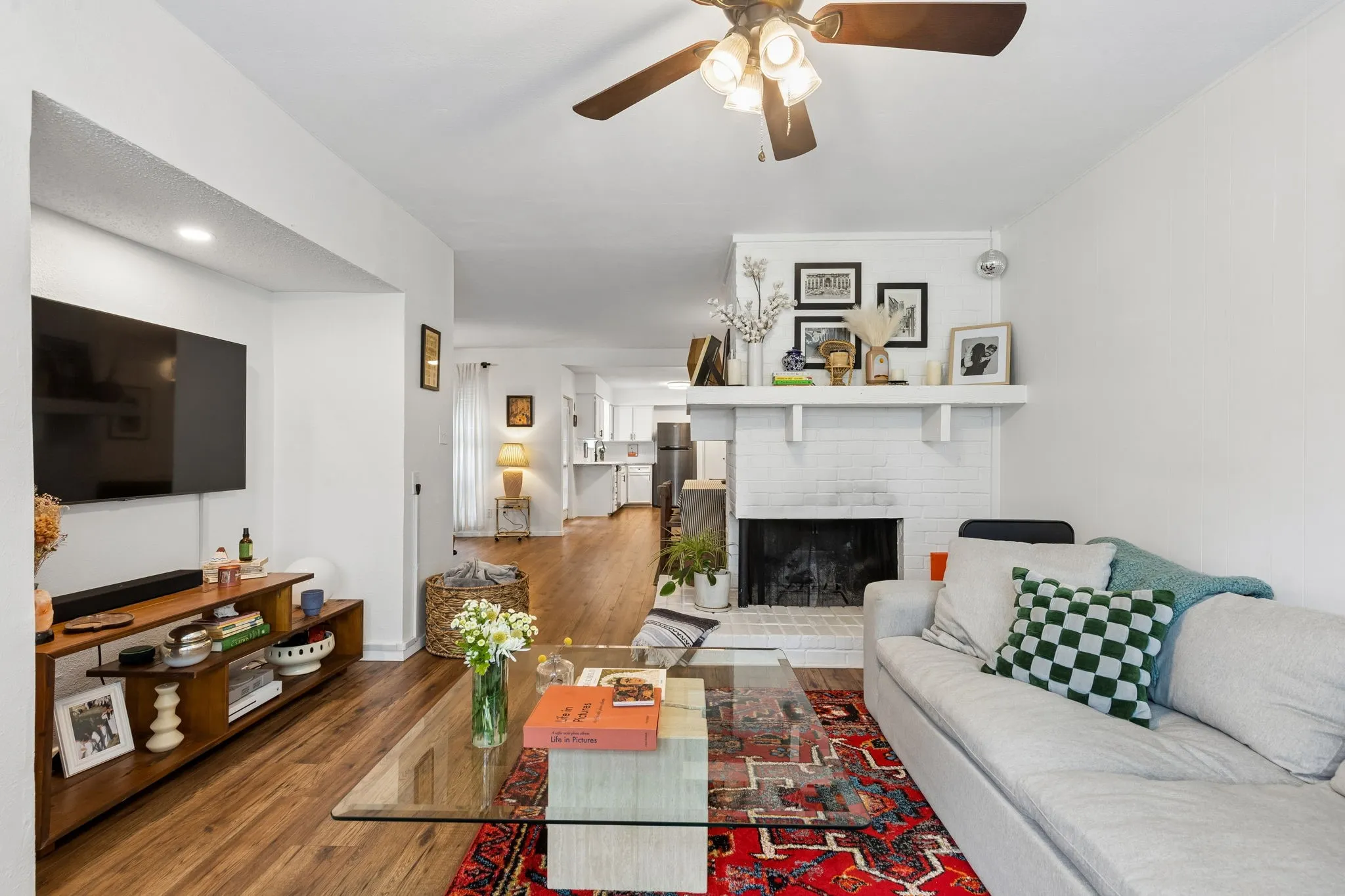 A working fireplace provides warmth and dimension to the living room.