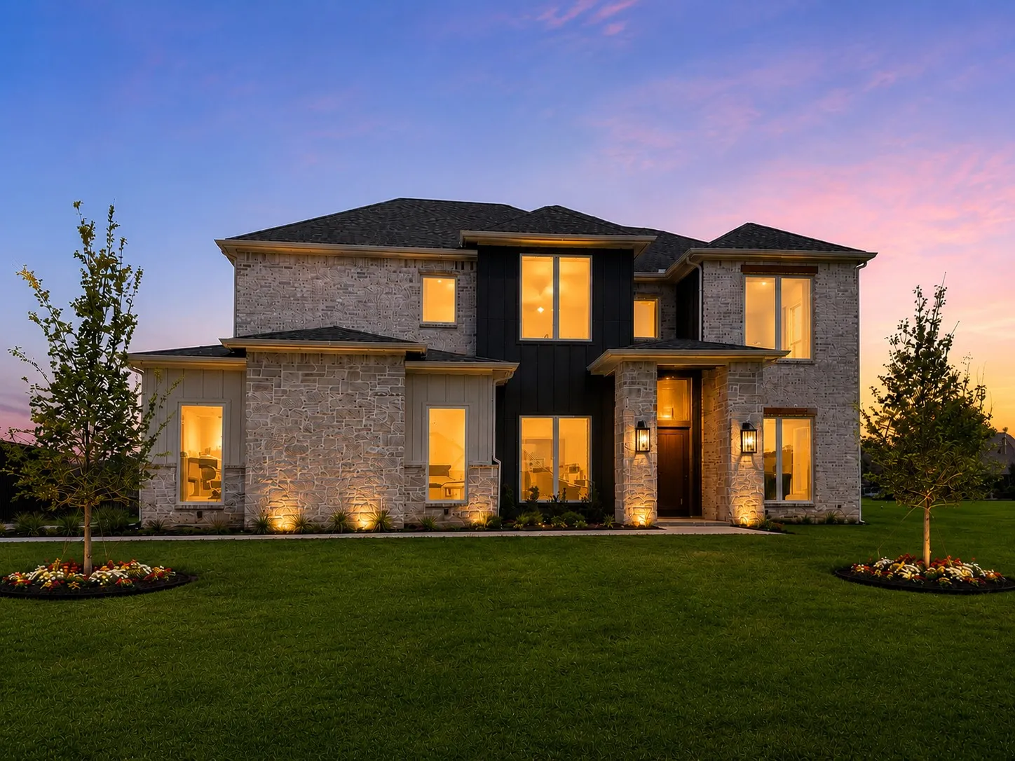 Contemporary two-story residence featuring a stone and dark vertical siding exterior