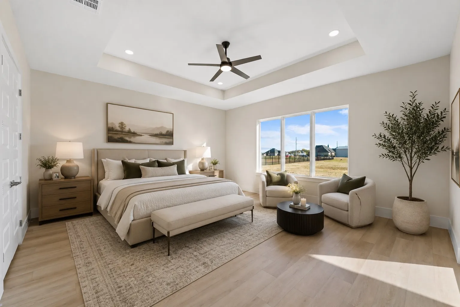 Spacious room featuring a ceiling fan, recessed lighting, and wood-finish flooring