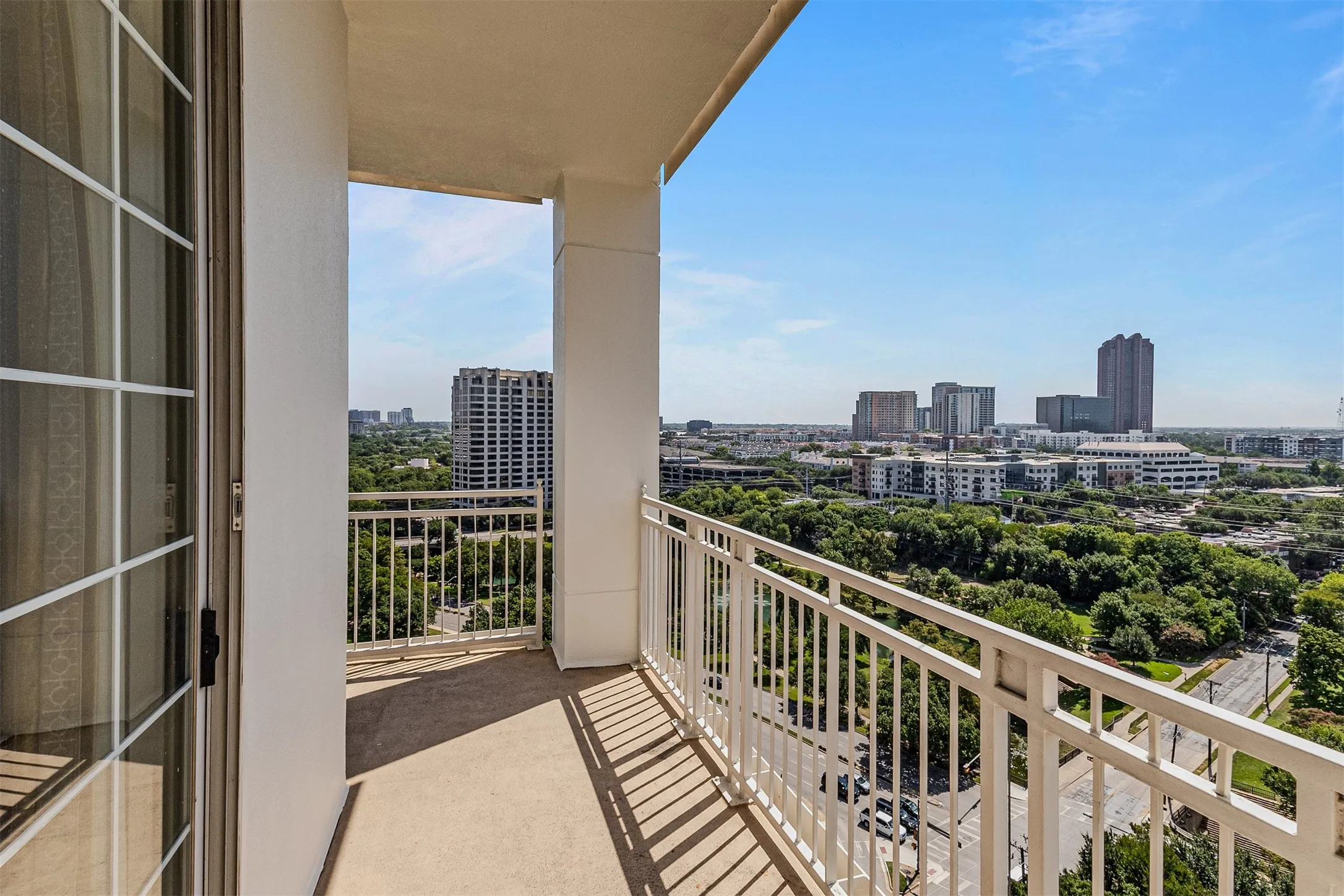 Private balcony featuring a concrete floor and white metal railing