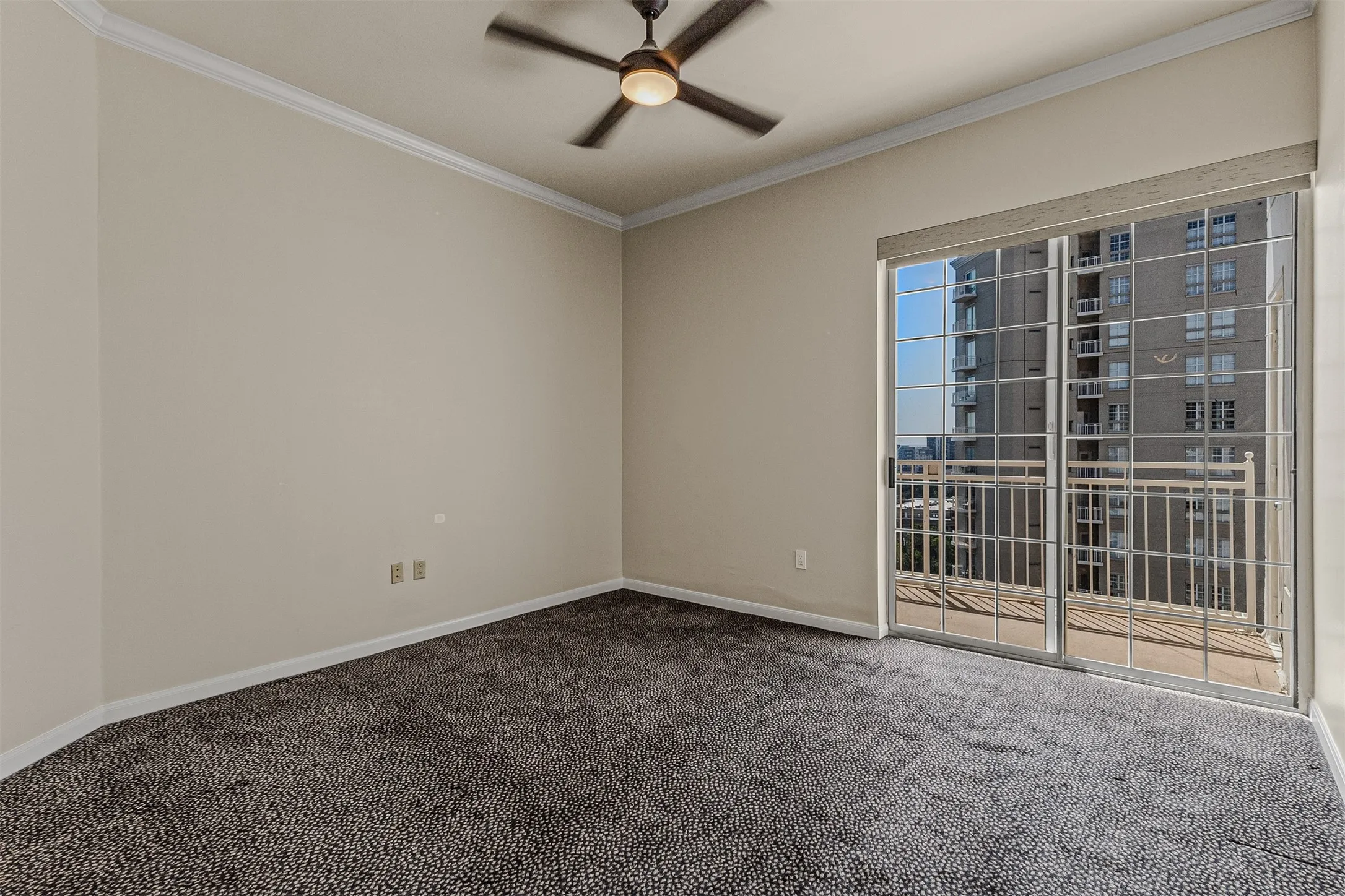Main bedroom includes a ceiling fan and a balcony