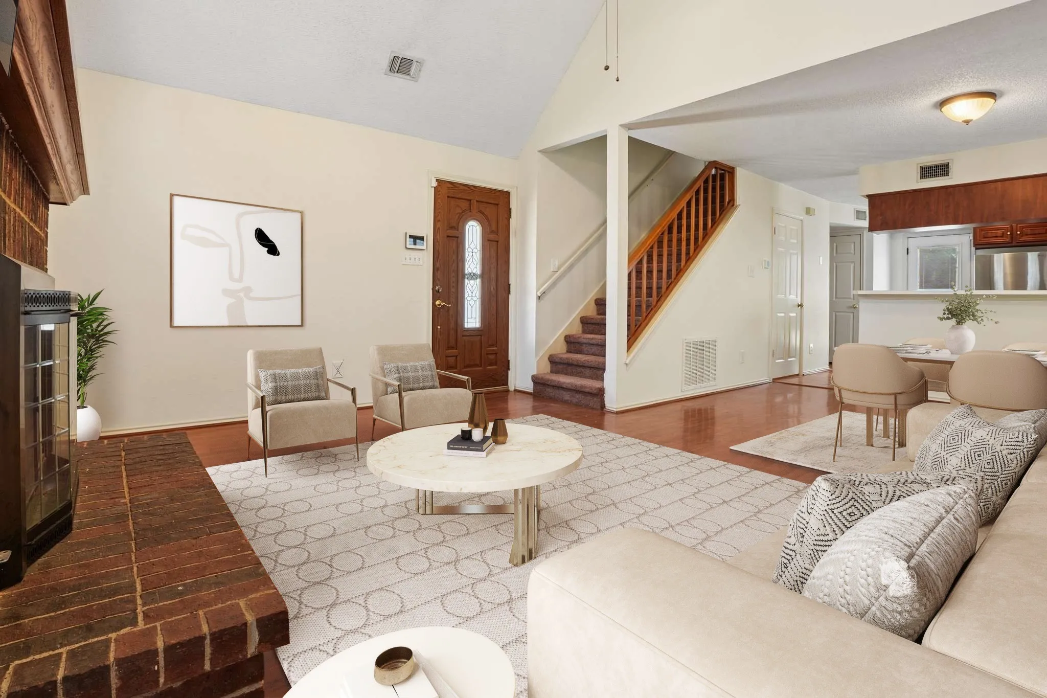 Living area featuring a brick fireplace, wood-finish flooring, and a vaulted ceiling