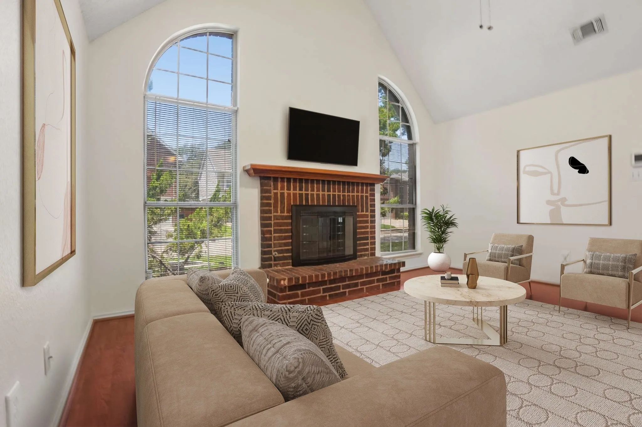 Living area with a vaulted ceiling, prominent brick fireplace, and arch-top windows