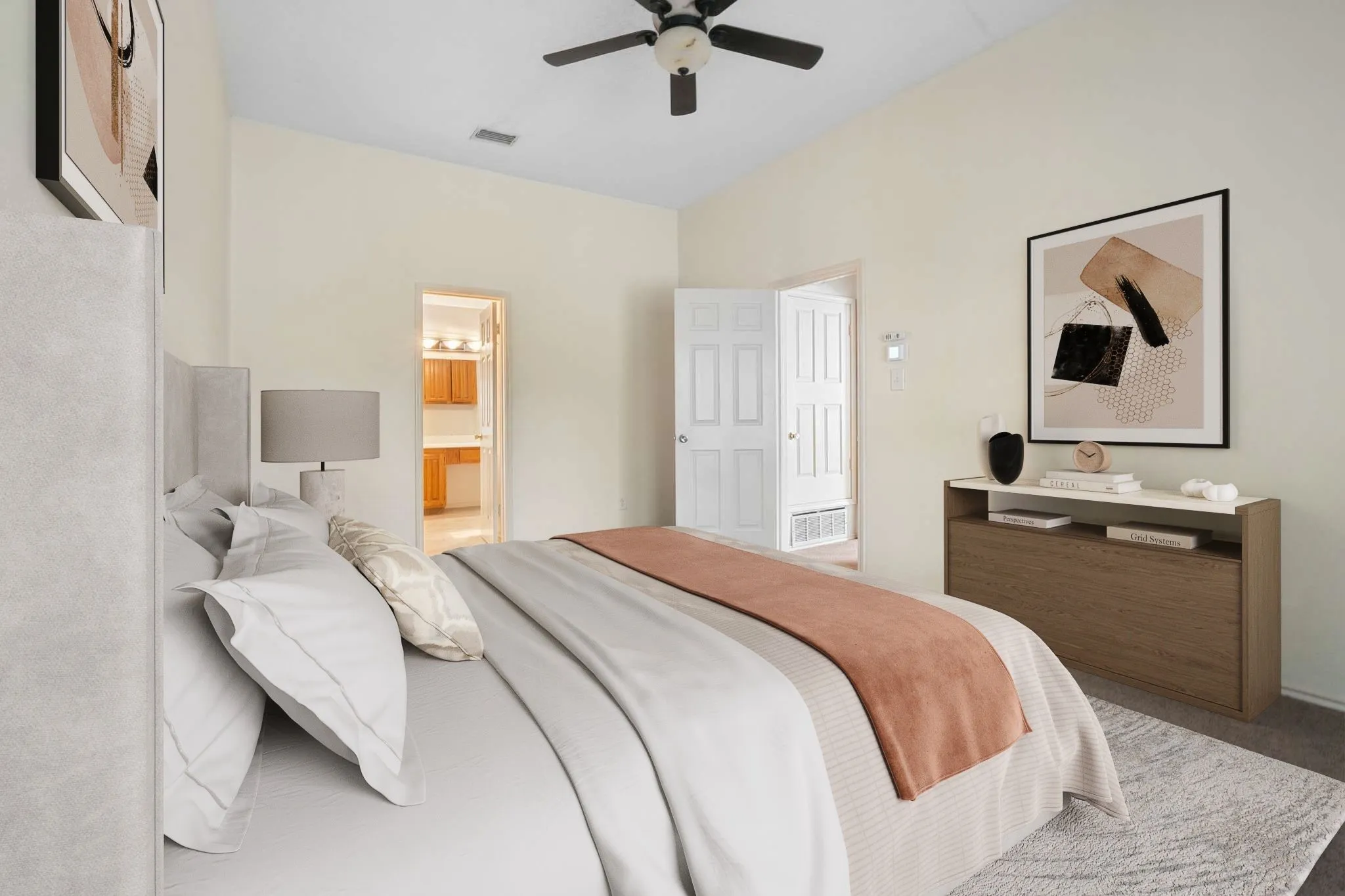Vaulted ceilings with a ceiling fan, light-toned wall finishes, and carpeted flooring