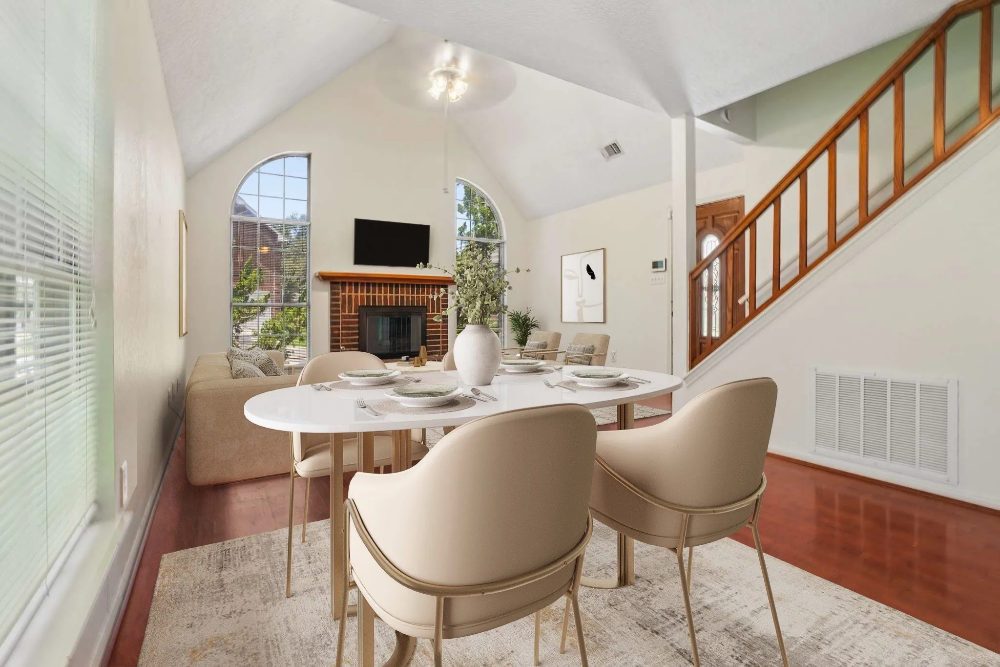 Dining area featuring hardwood flooring, a vaulted ceiling, and arched window details