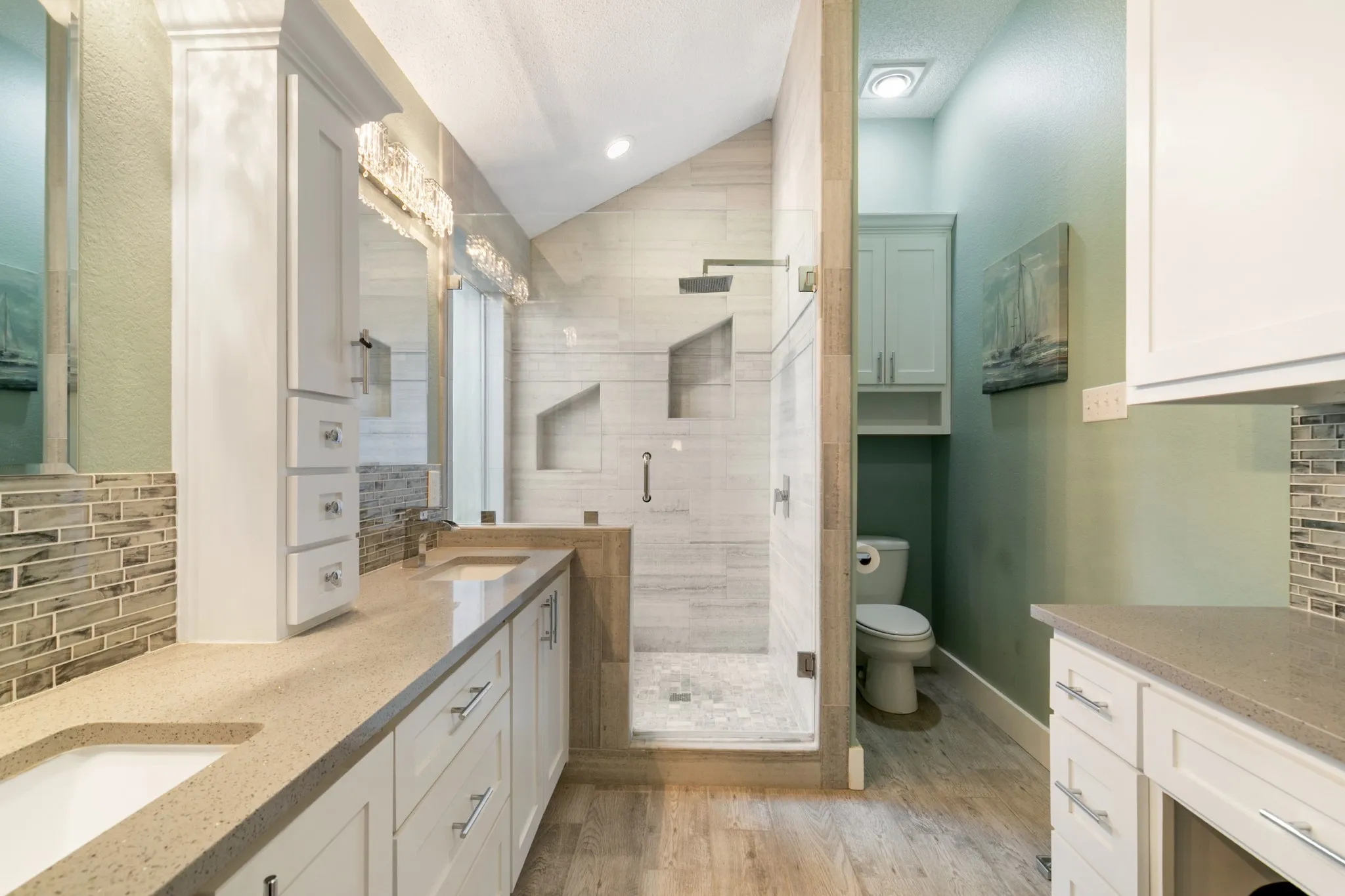 Features: designer finishes, dual sinks, a separate vanity area with knee space, a large shower with a built-in bench seat & dual shampoo niches, ample storage and great natural light!