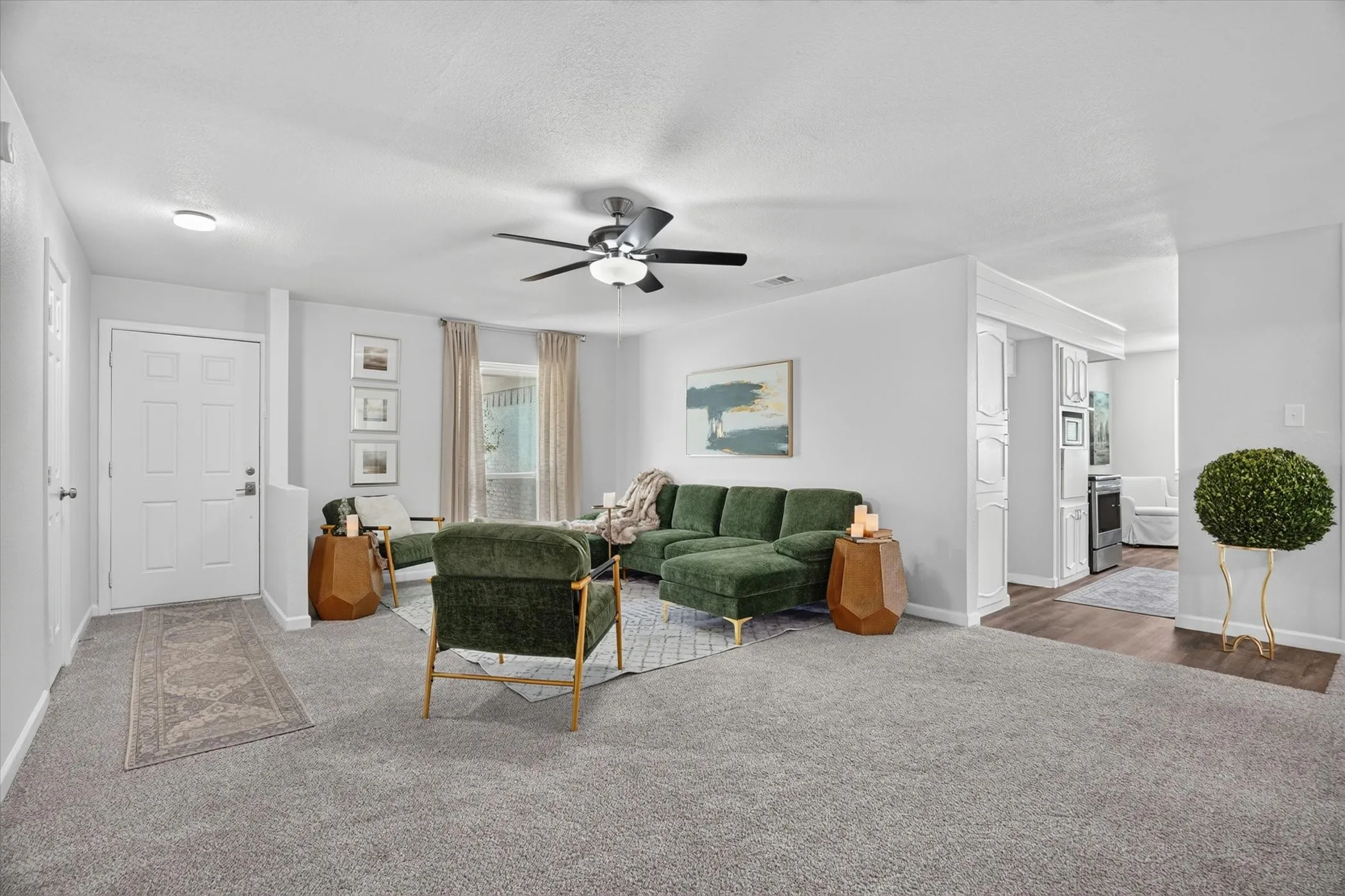 Spacious interior featuring light gray wall paint and matching gray carpeting