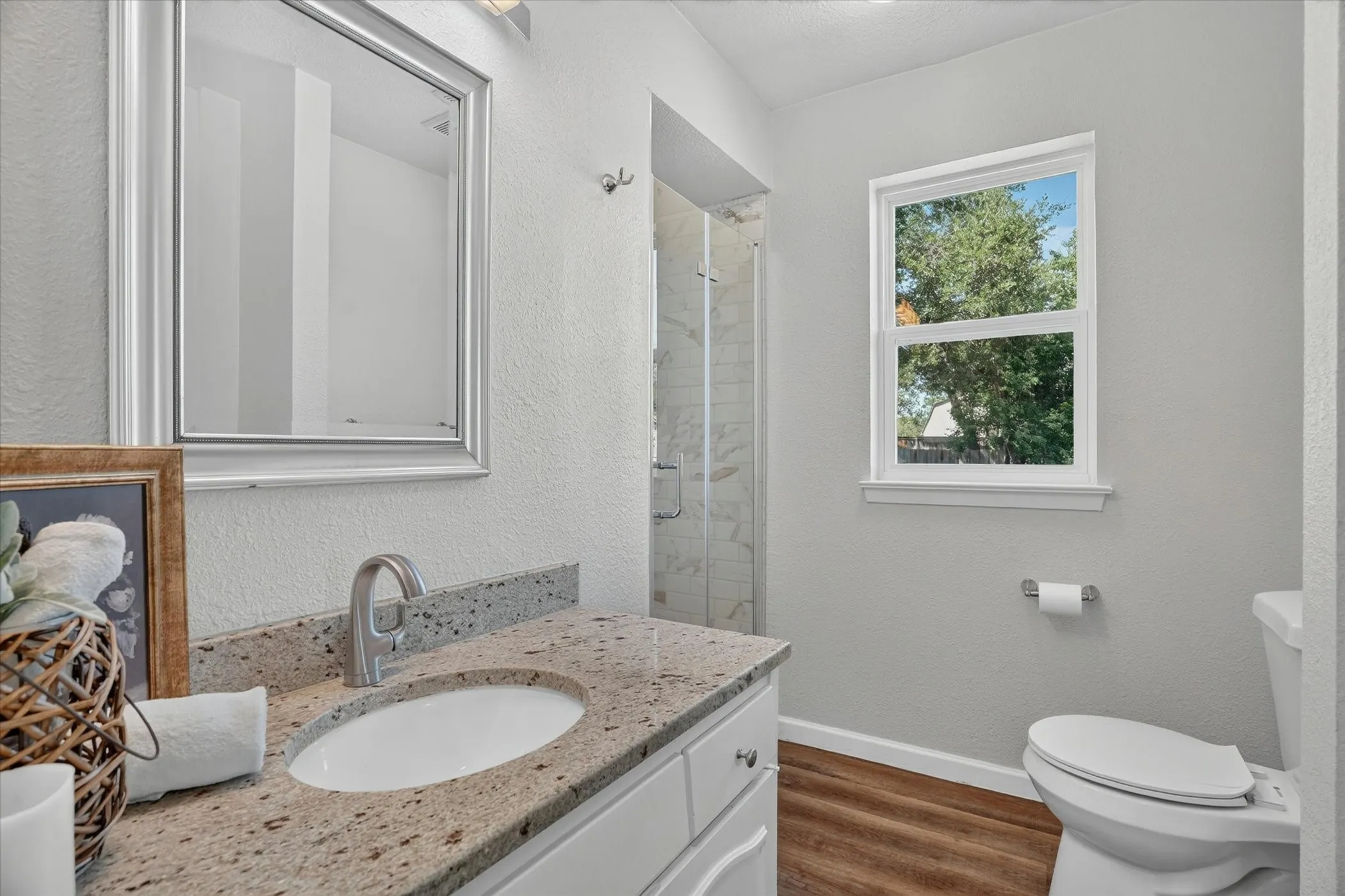 Bathroom featuring a vanity with a light-toned countertop, undermount sink, and brushed nickel faucet