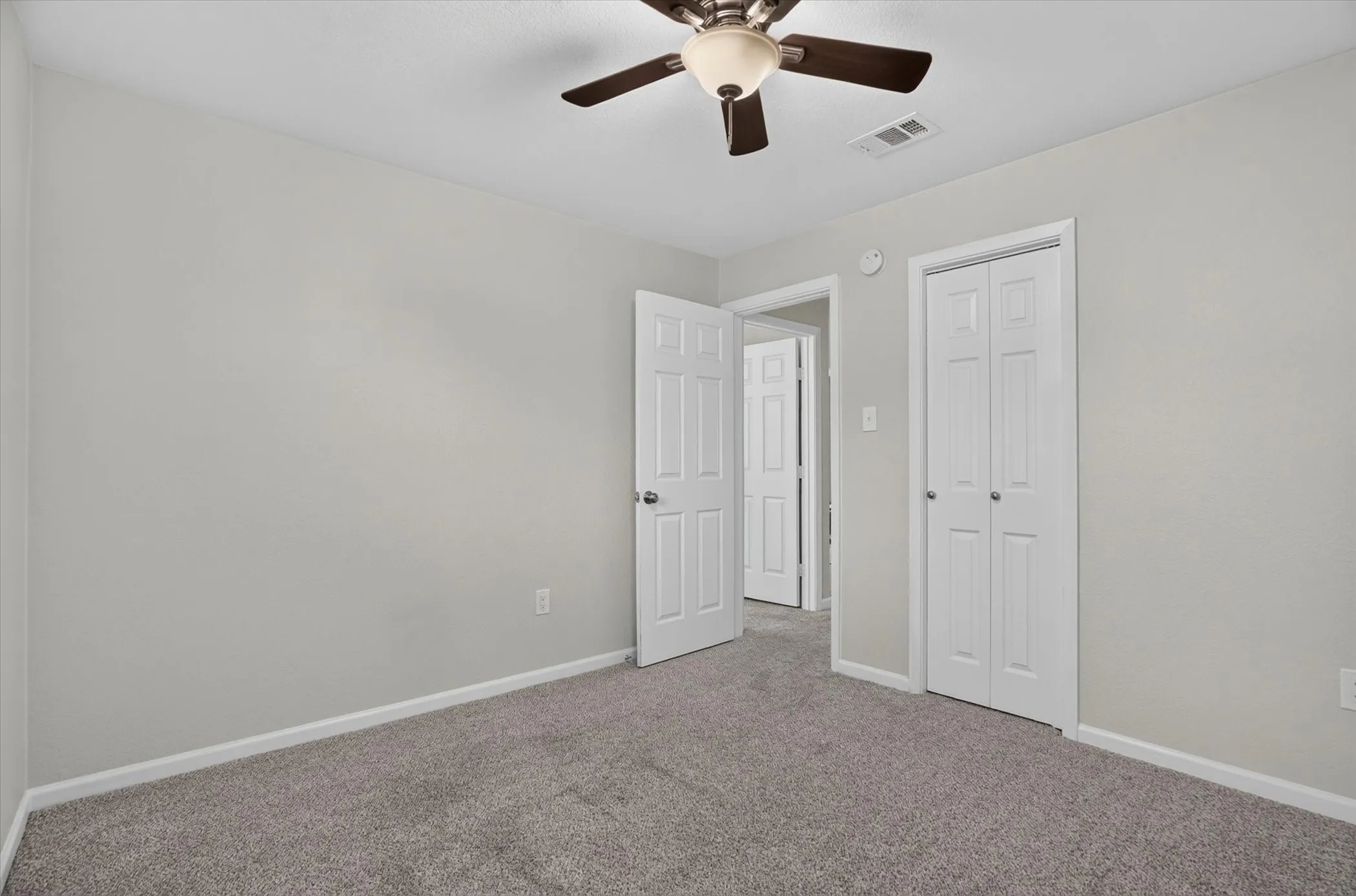 Neutral gray wall finishes complementing textured gray carpeting