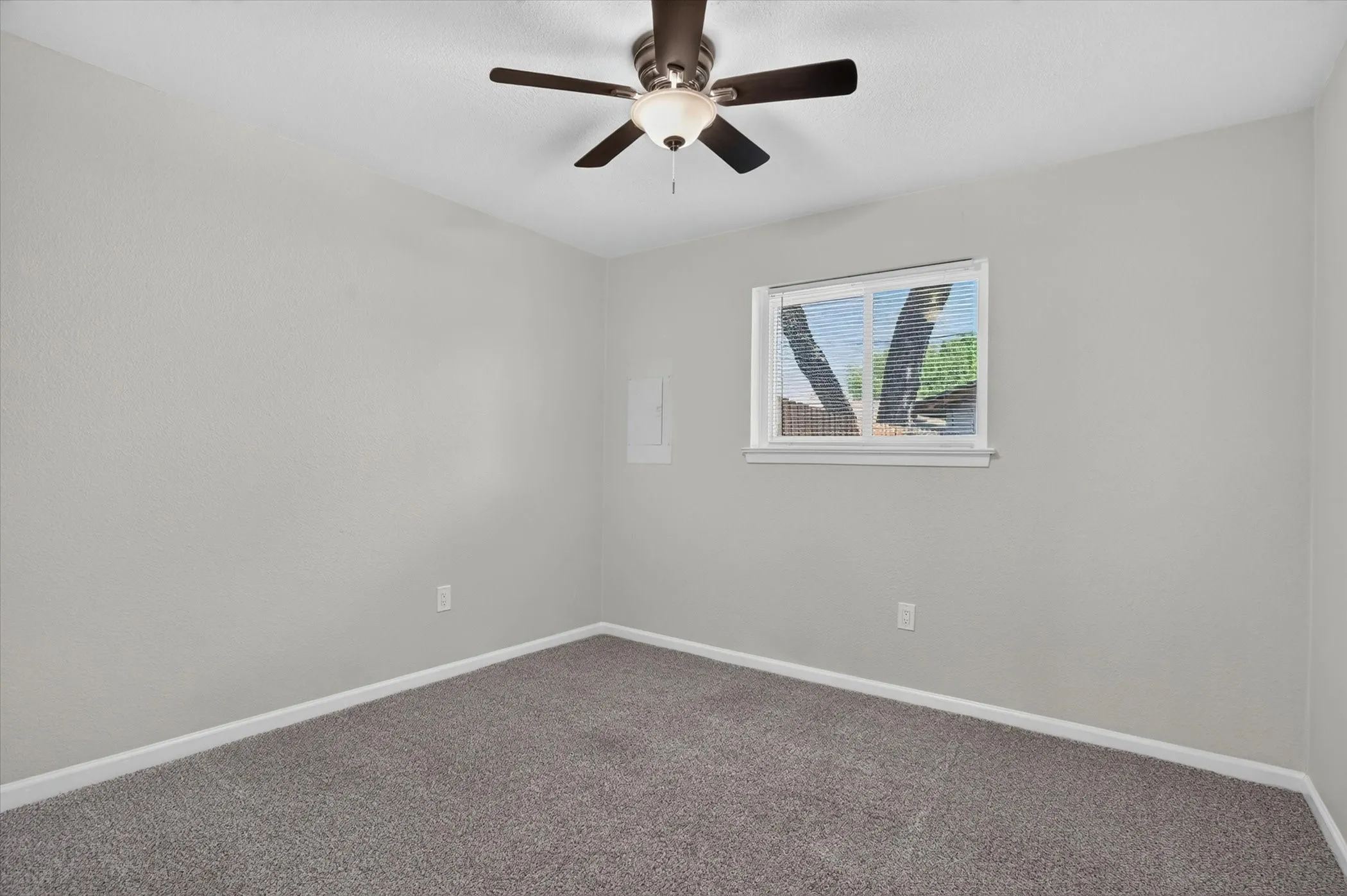 Neutral-toned carpeting paired with light gray walls
