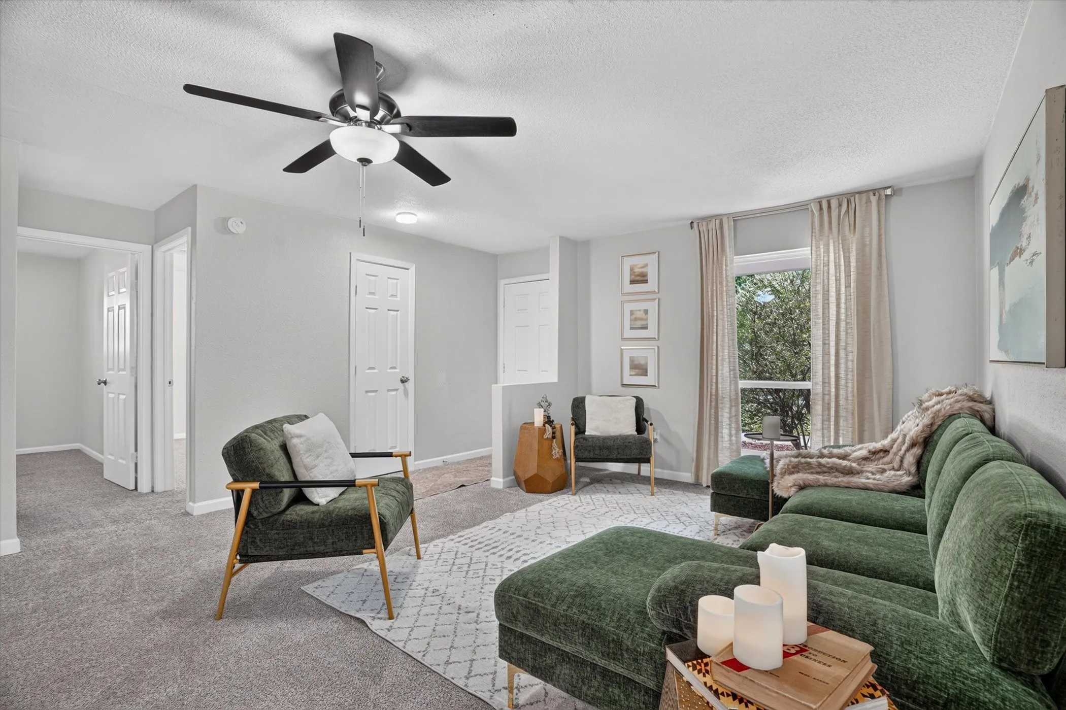 Spacious living area featuring light gray wall paint, recessed lighting, and a ceiling fan with integrated lighting