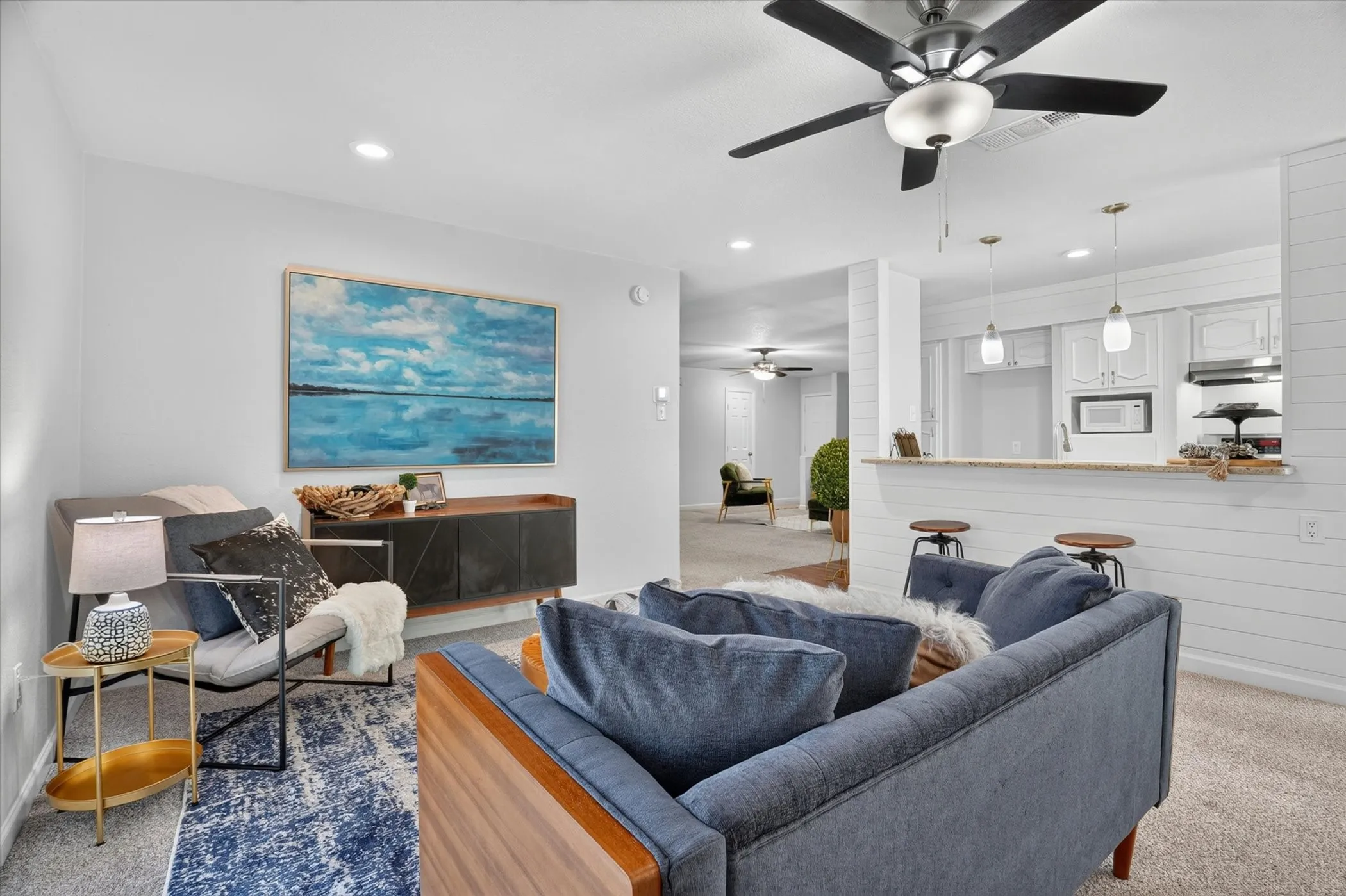 Open-concept living space featuring recessed lighting, a ceiling fan, and carpet flooring