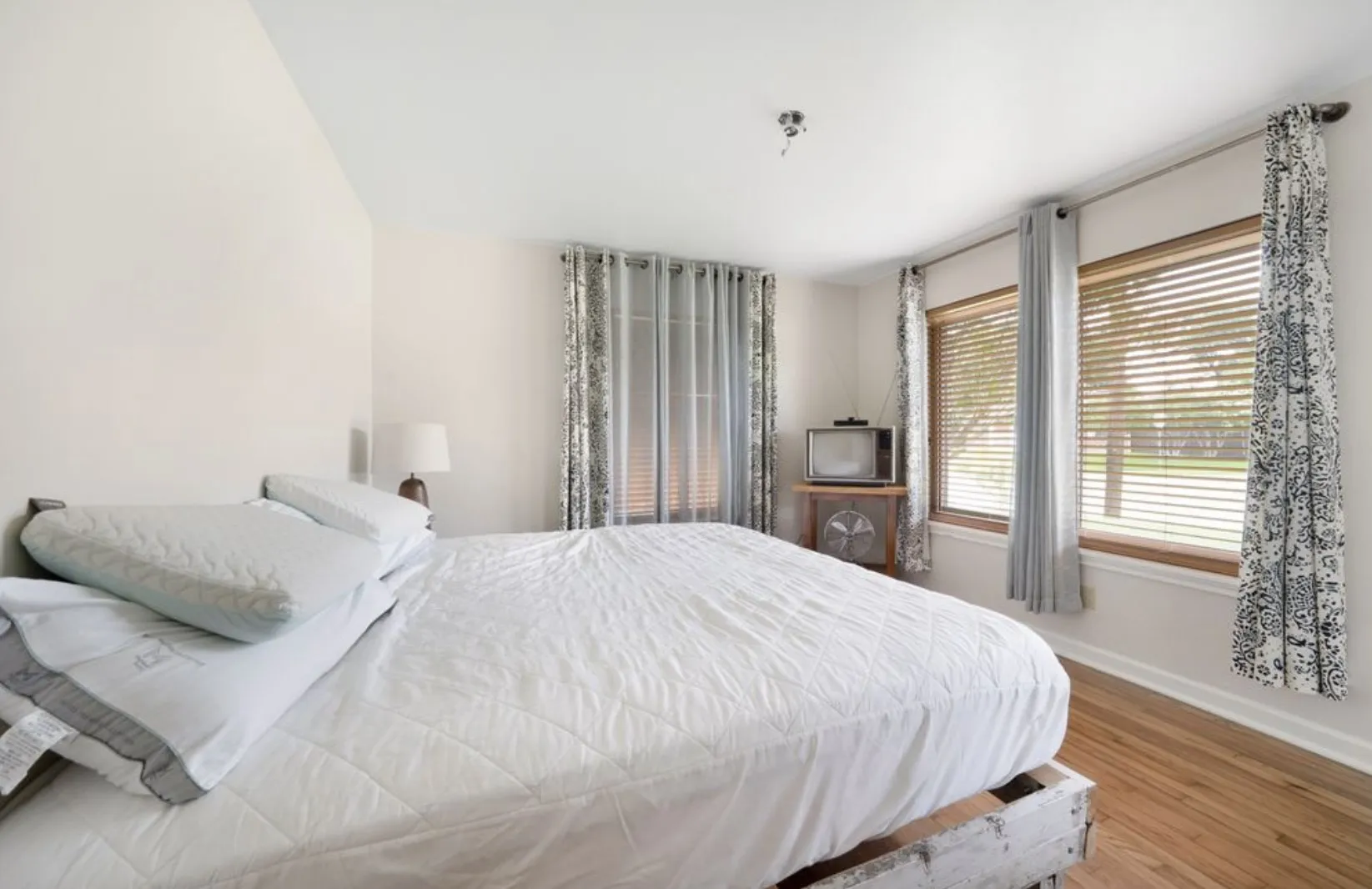 Primary bedroom has great windows on multiple walls.