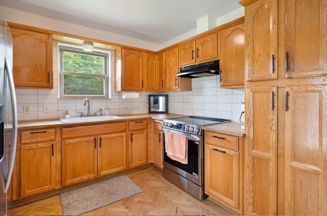 warm wood and updated appliances, that has custom cabinetry throughout