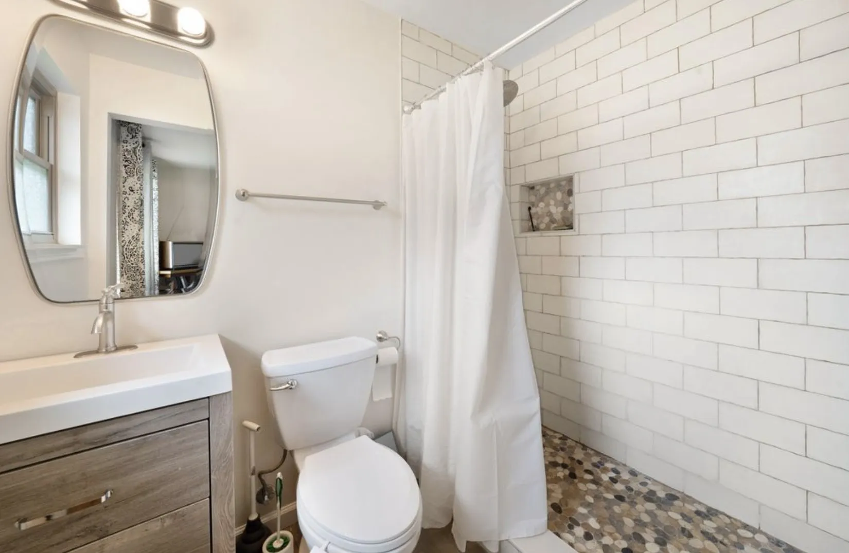 ensuite primary bathroom with wonderful tile work
