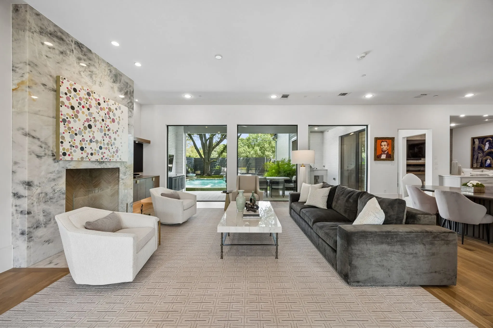 Living room with huge windows overlooking pool